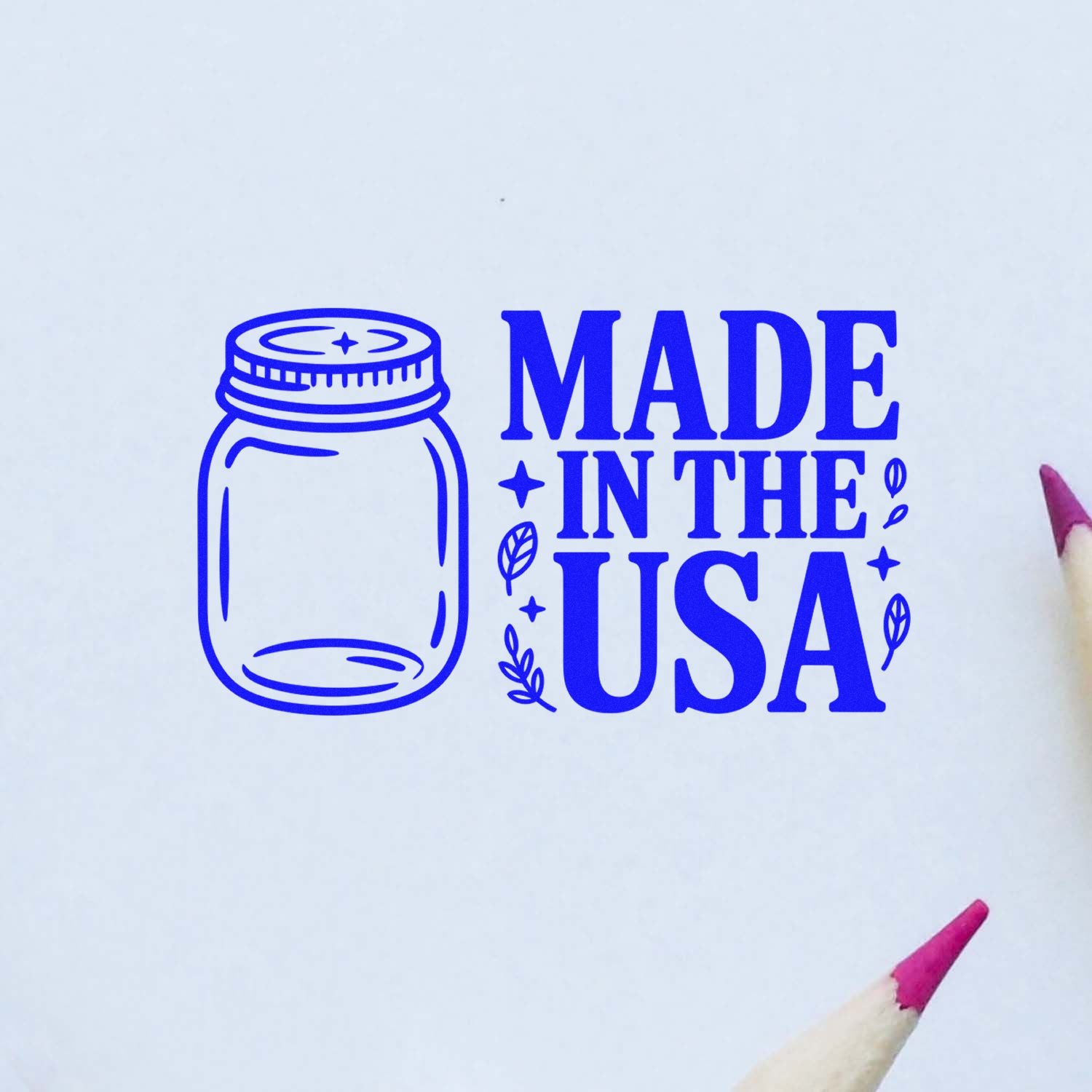Blue stamp seal reading Made in the USA with mason jar icon and leaf accents on white background
