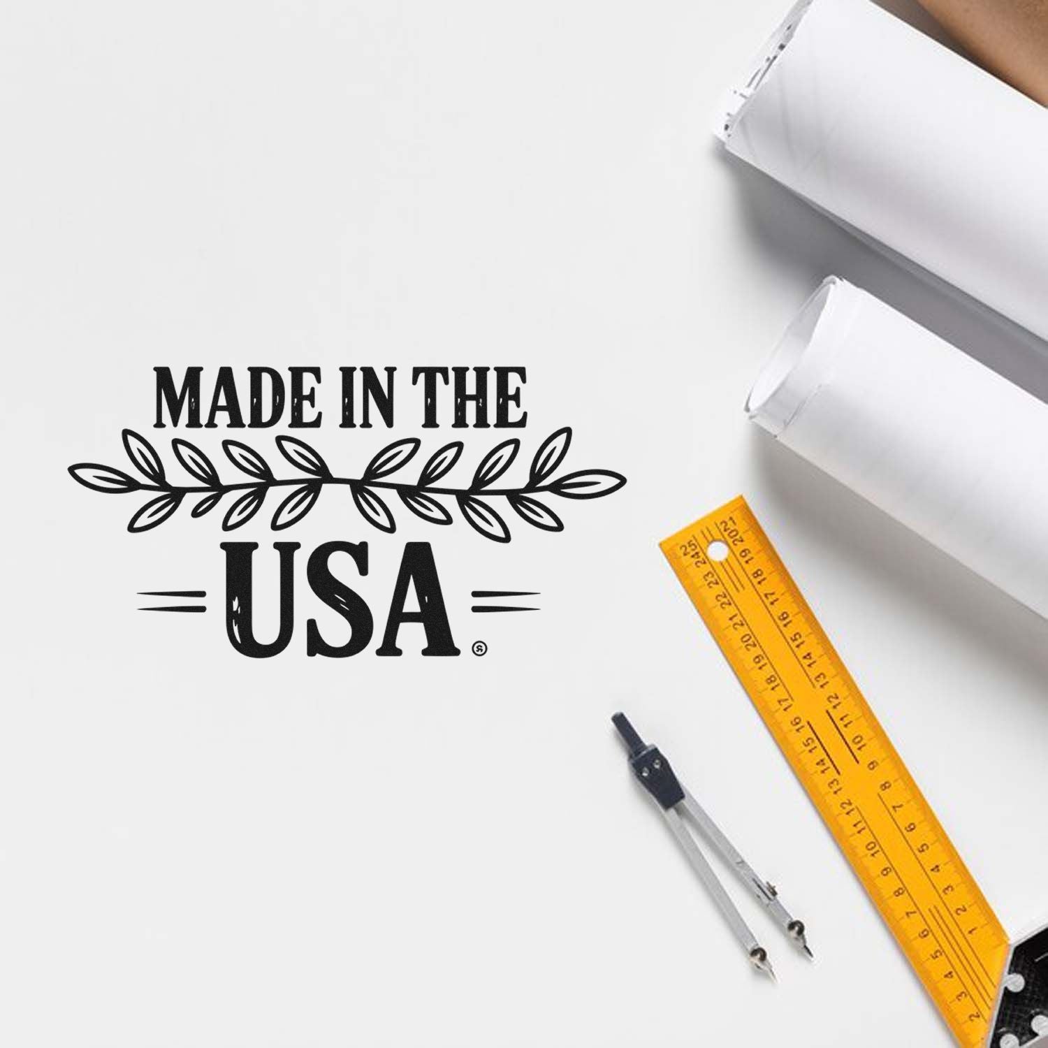Black Made in the USA stamp design on white paper with yellow ruler and compass, showing custom stamp and seal products.