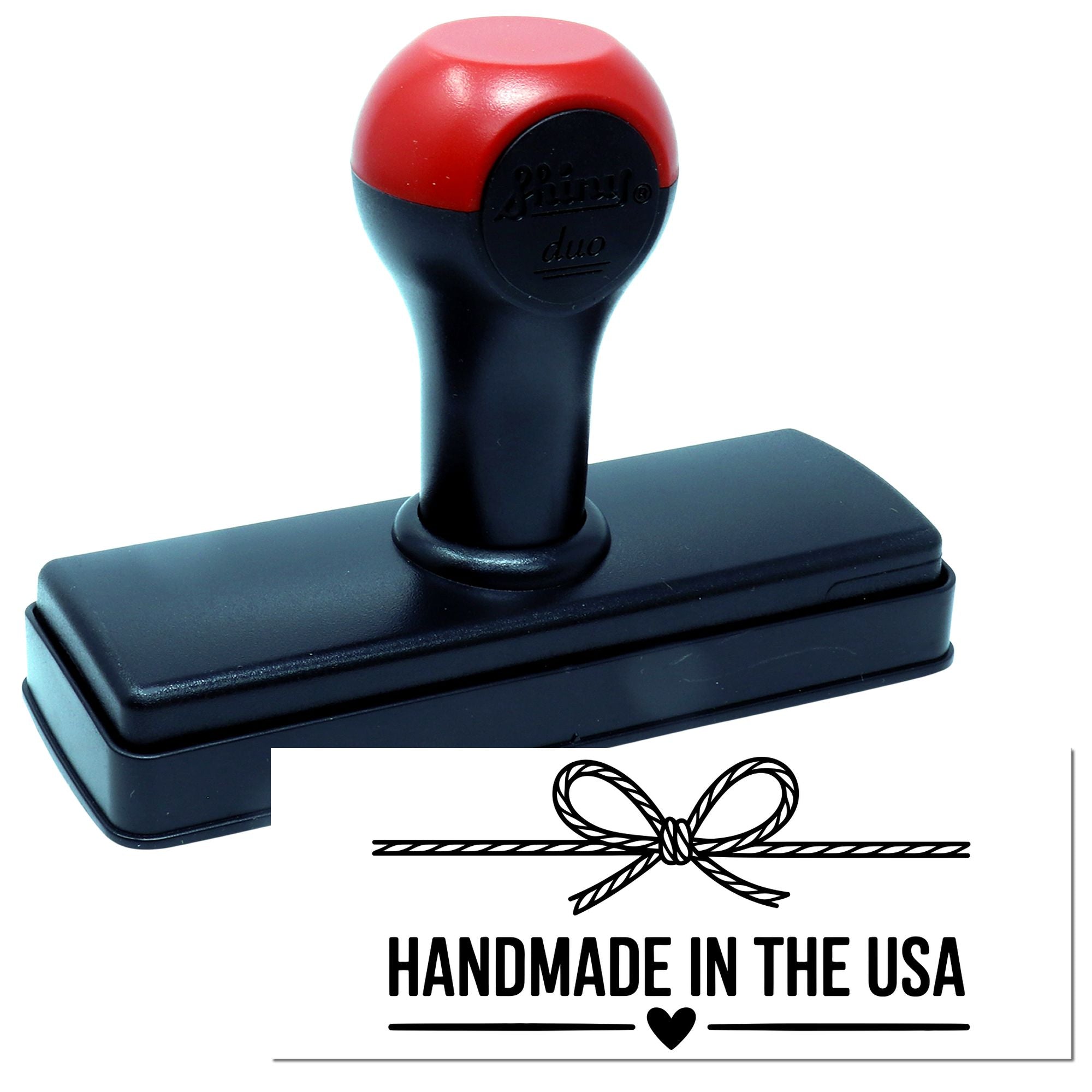 Red and black self-inking stamp with rectangular base and Handmade in the USA seal design with bow icon