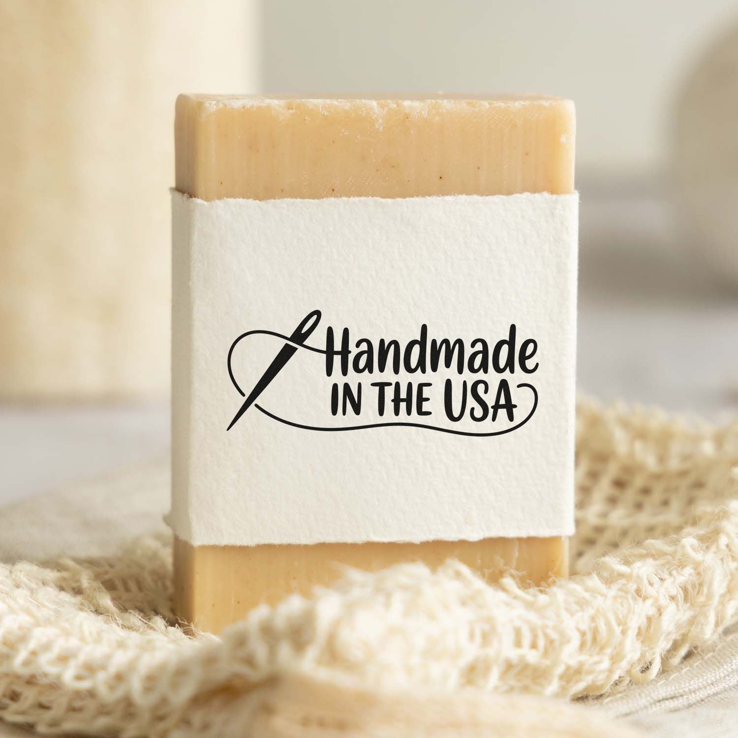 Beige handmade stamp seal on white wrap with black Handmade in the USA text