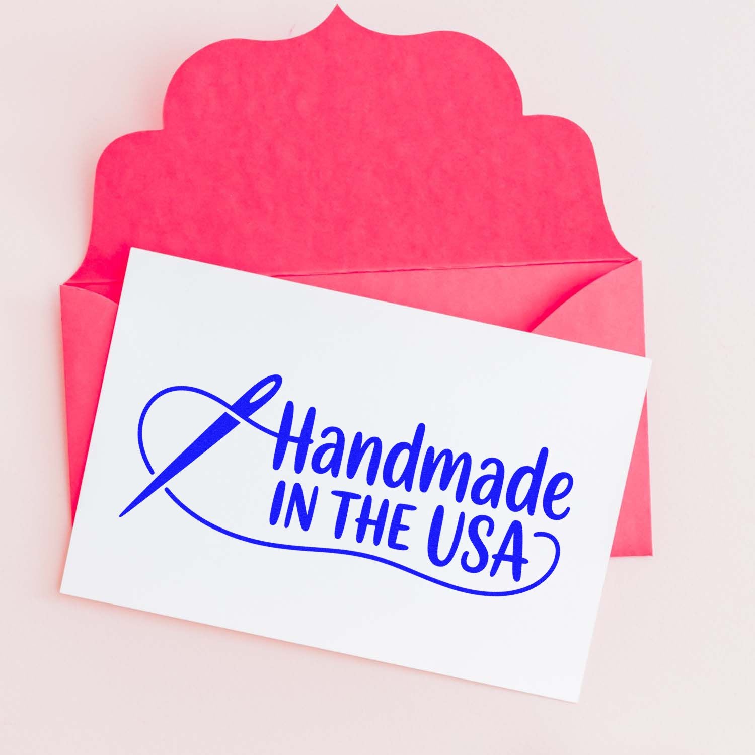 White card with blue Handmade in the USA stamp, shown over a bright pink scalloped seal envelope.