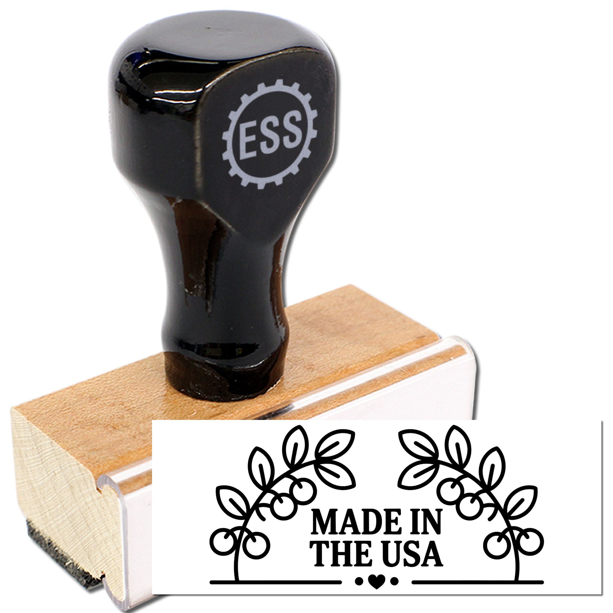 Black ESS rubber stamp and wooden seal with floral Made in the USA imprint on white background.