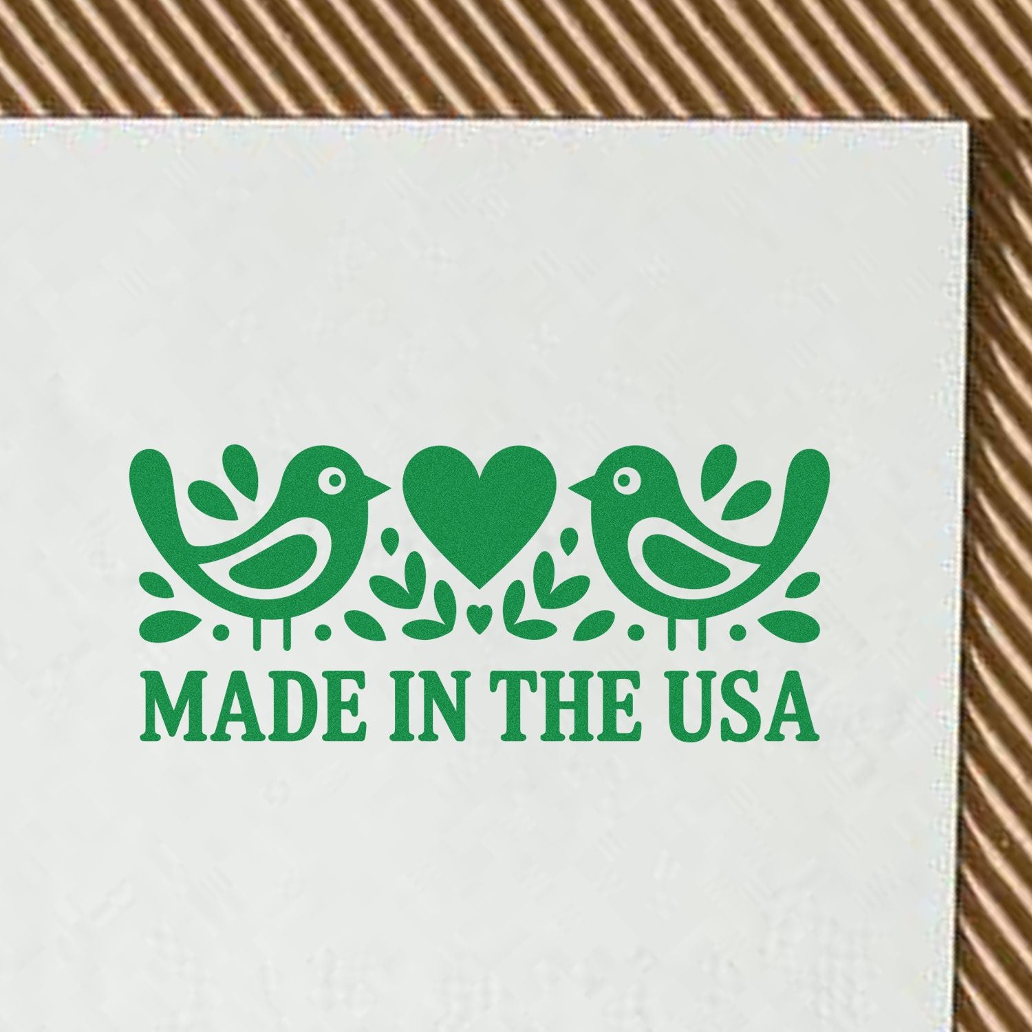 Green Made in the USA rubber stamp seal with two birds and heart on white background
