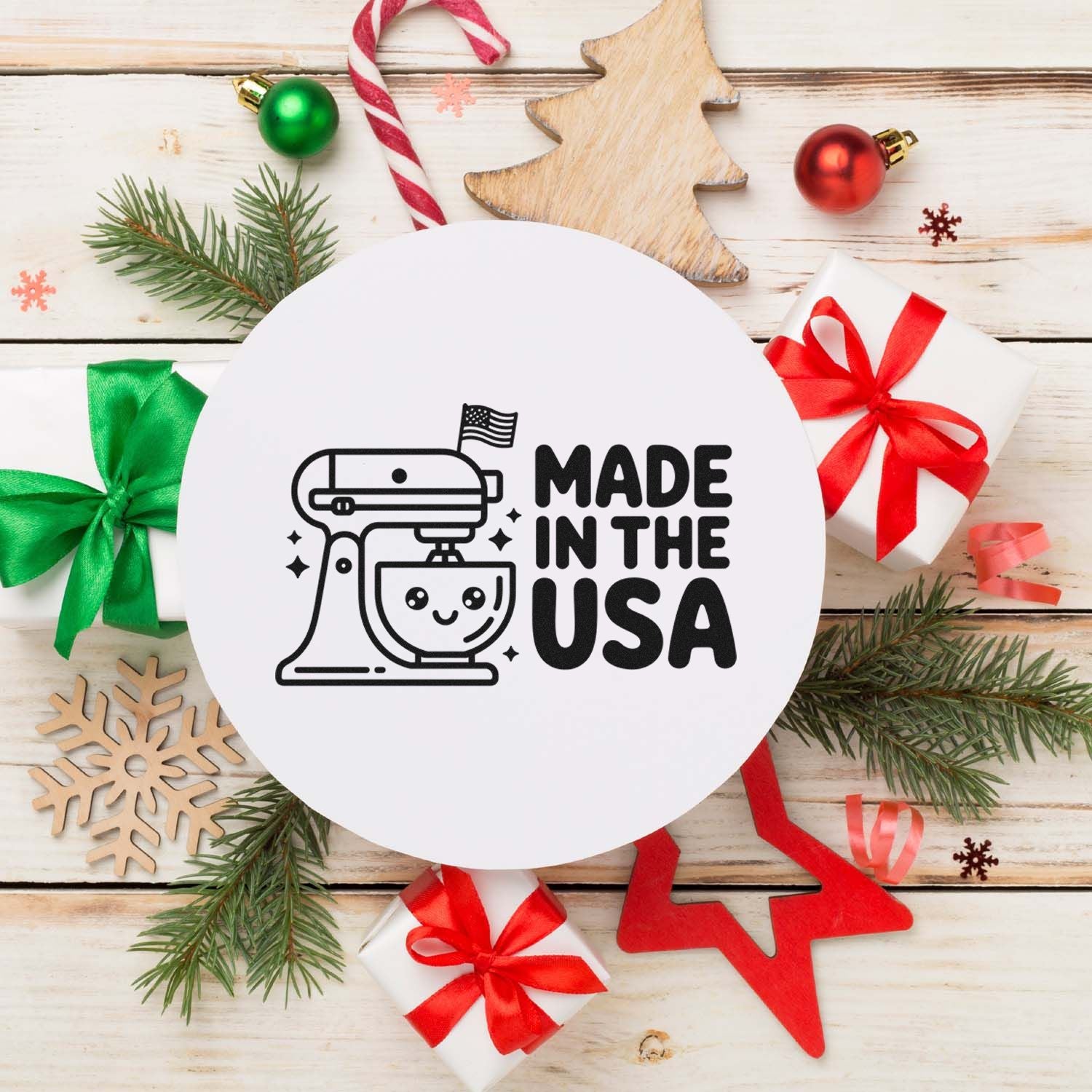 White round stamp seal with black Made in the USA mixer design, framed by red, green and white Christmas decor.