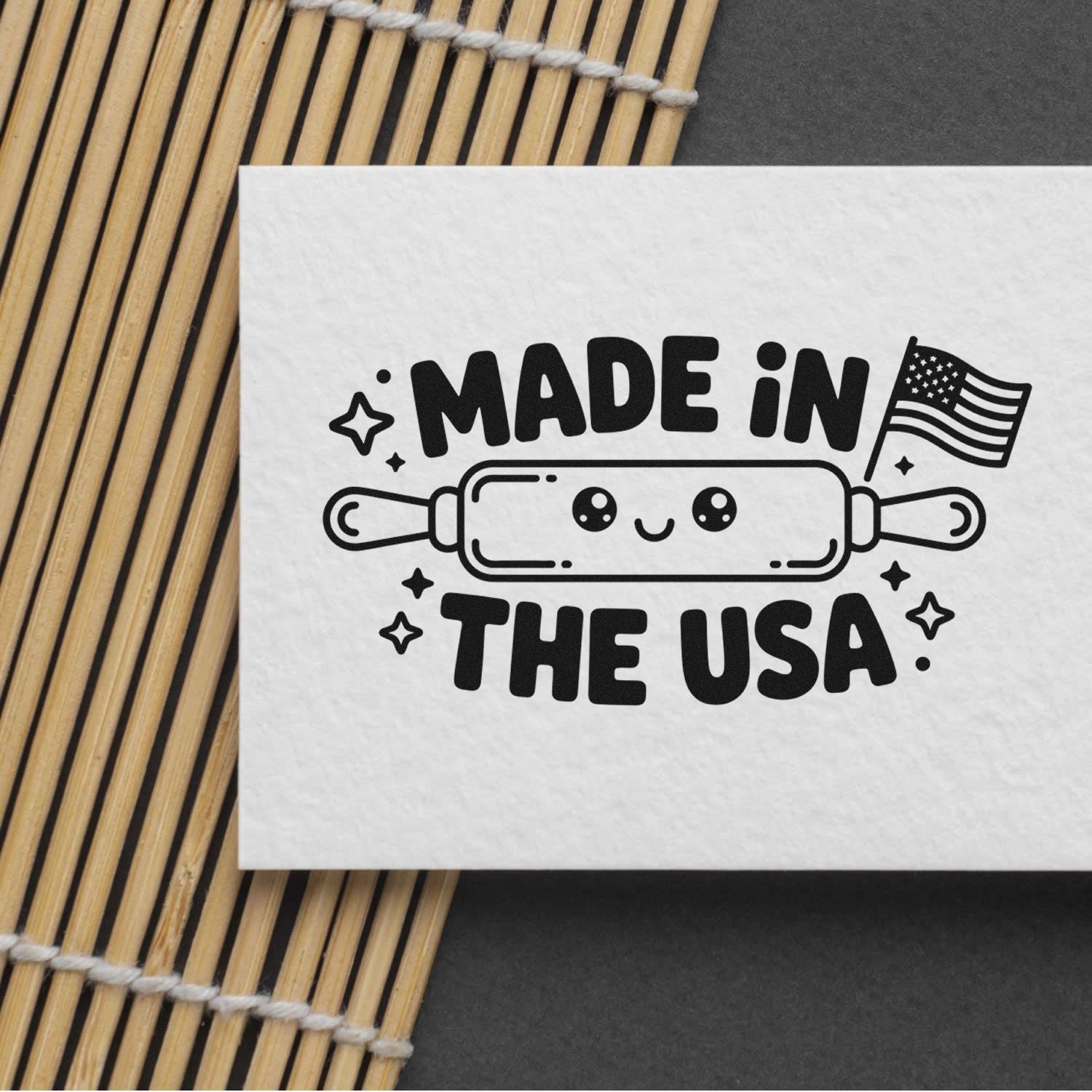 Black-and-white Made in the USA stamp and seal design with rolling pin, stars, and American flag on white paper.