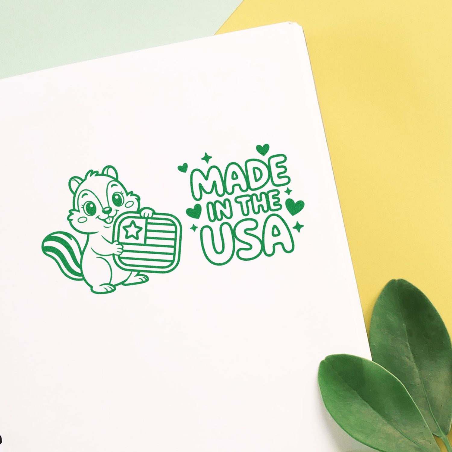 Green Made in the USA stamp and seal design with chipmunk holding a U.S. flag shield on white paper, yellow background.