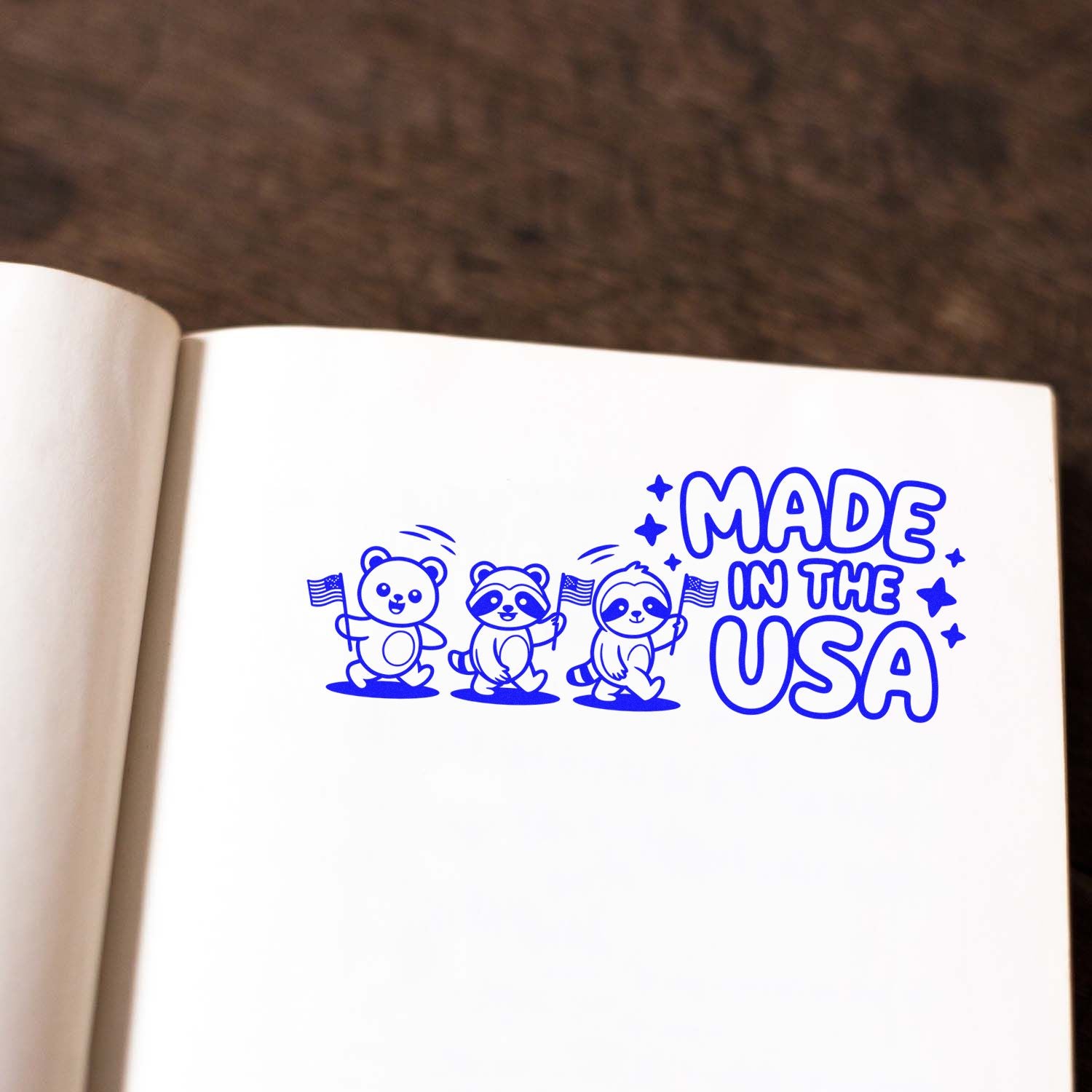 Blue custom stamp seal with three cartoon bears and MADE IN THE USA on white paper.