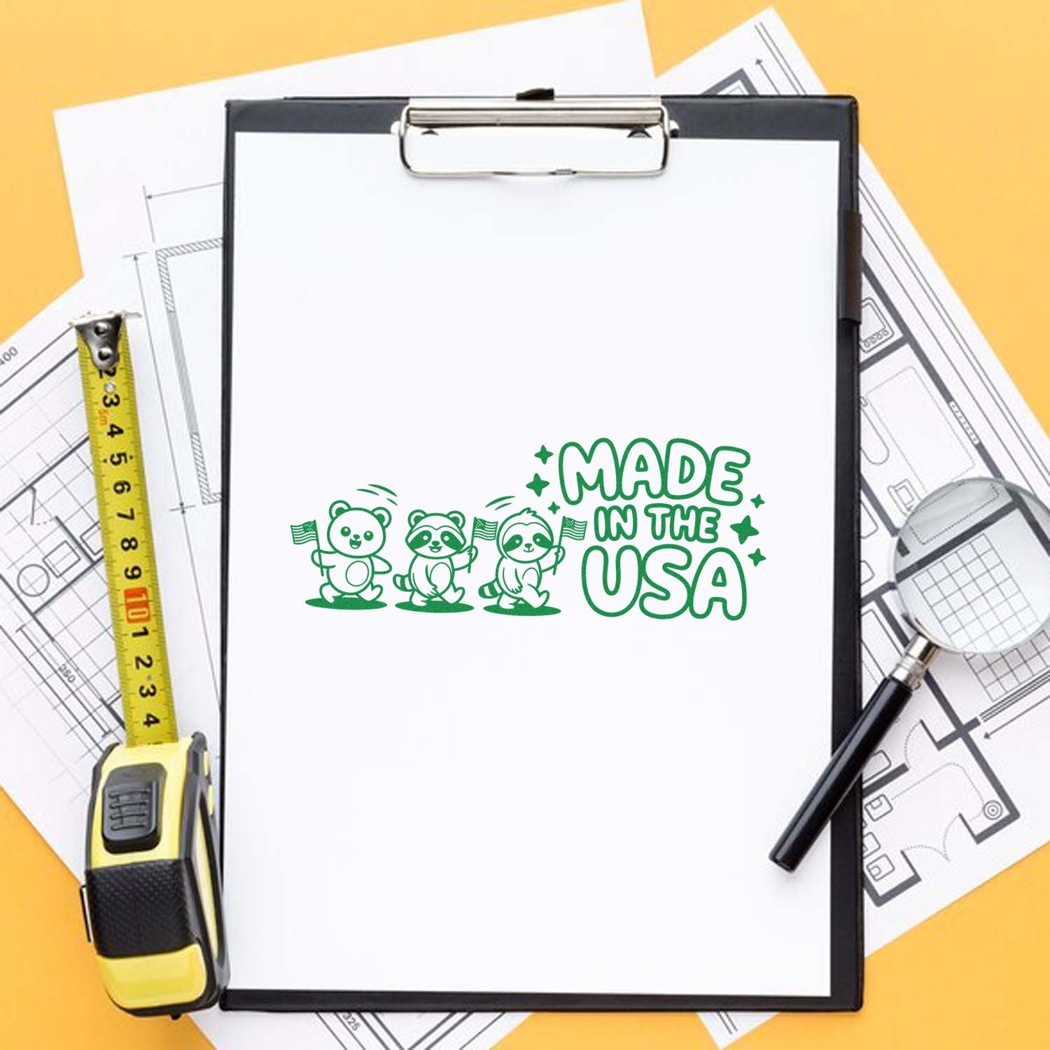 Green Made in the USA stamp and seal design with panda mascots on a clipboard, on blueprints with a yellow tape measure and black pen.