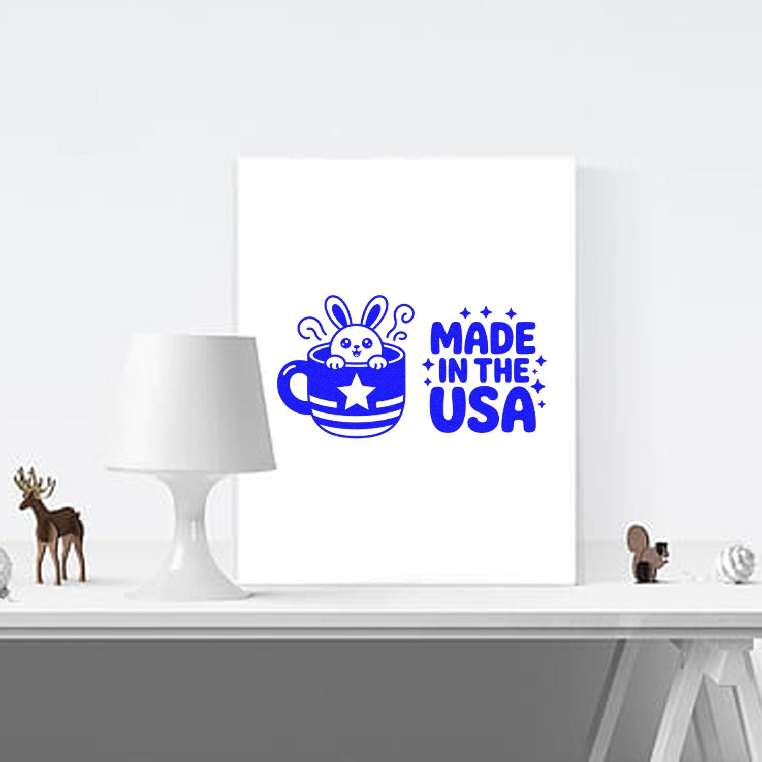 Blue Made in the USA stamp and seal design with bunny in a cup on a white display board.