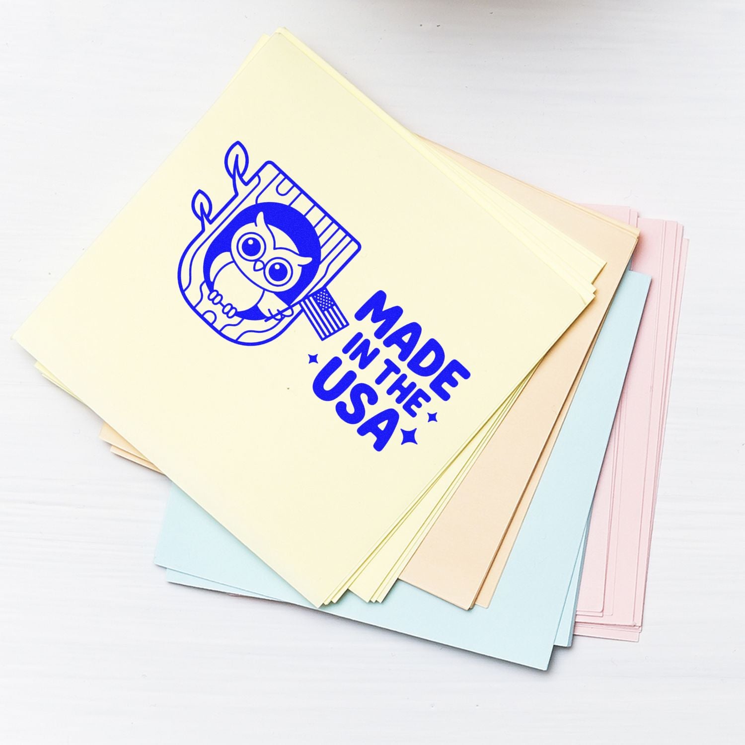 Pastel stamp and seal sample sheets with blue owl logo and Made in the USA text.