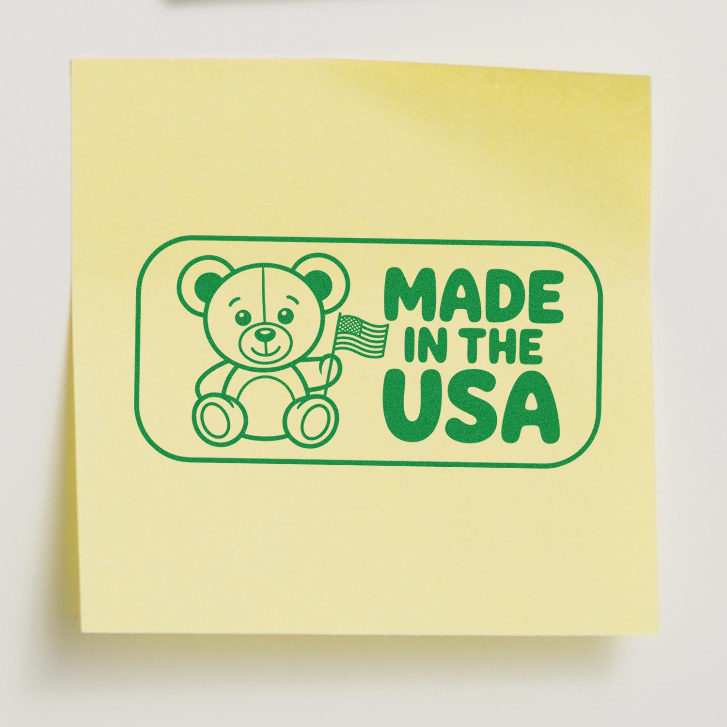Yellow stamp and seal product with green teddy bear and U.S. flag, labeled Made in the USA.