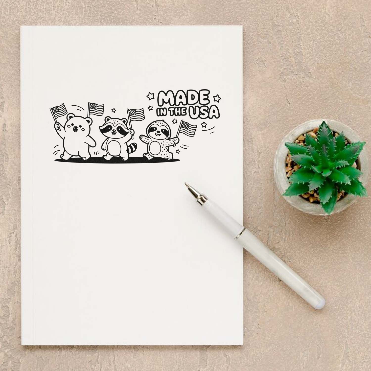 Black Made in the USA stamp and seal design with bear, raccoon and sloth waving flags on white paper, beside a green succulent.
