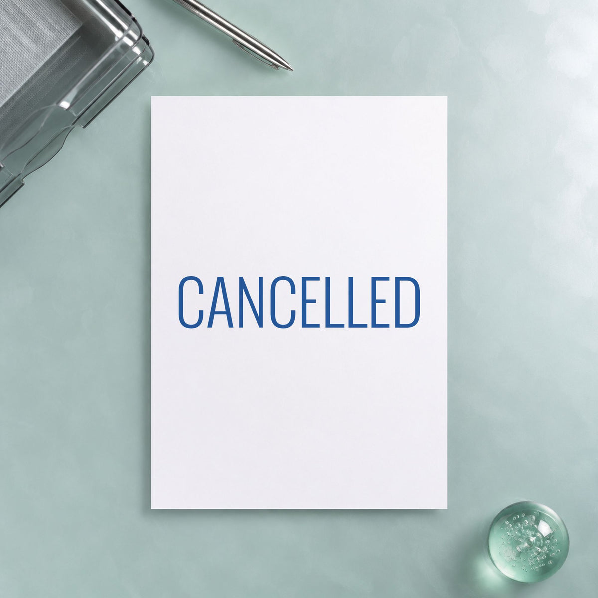 "Cancelled" Xstamper pre-inked stamp beside its rectangle imprint