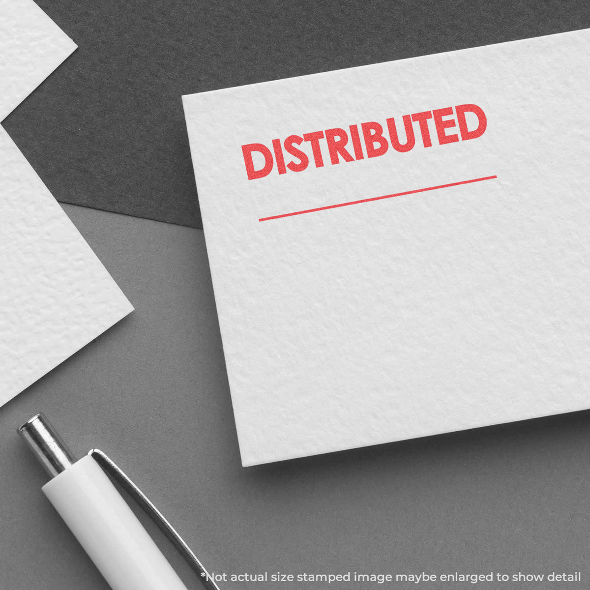 "Distributed" pre-inked imprint on a page, rectangle shape at 1/2 x 1-5/8 in