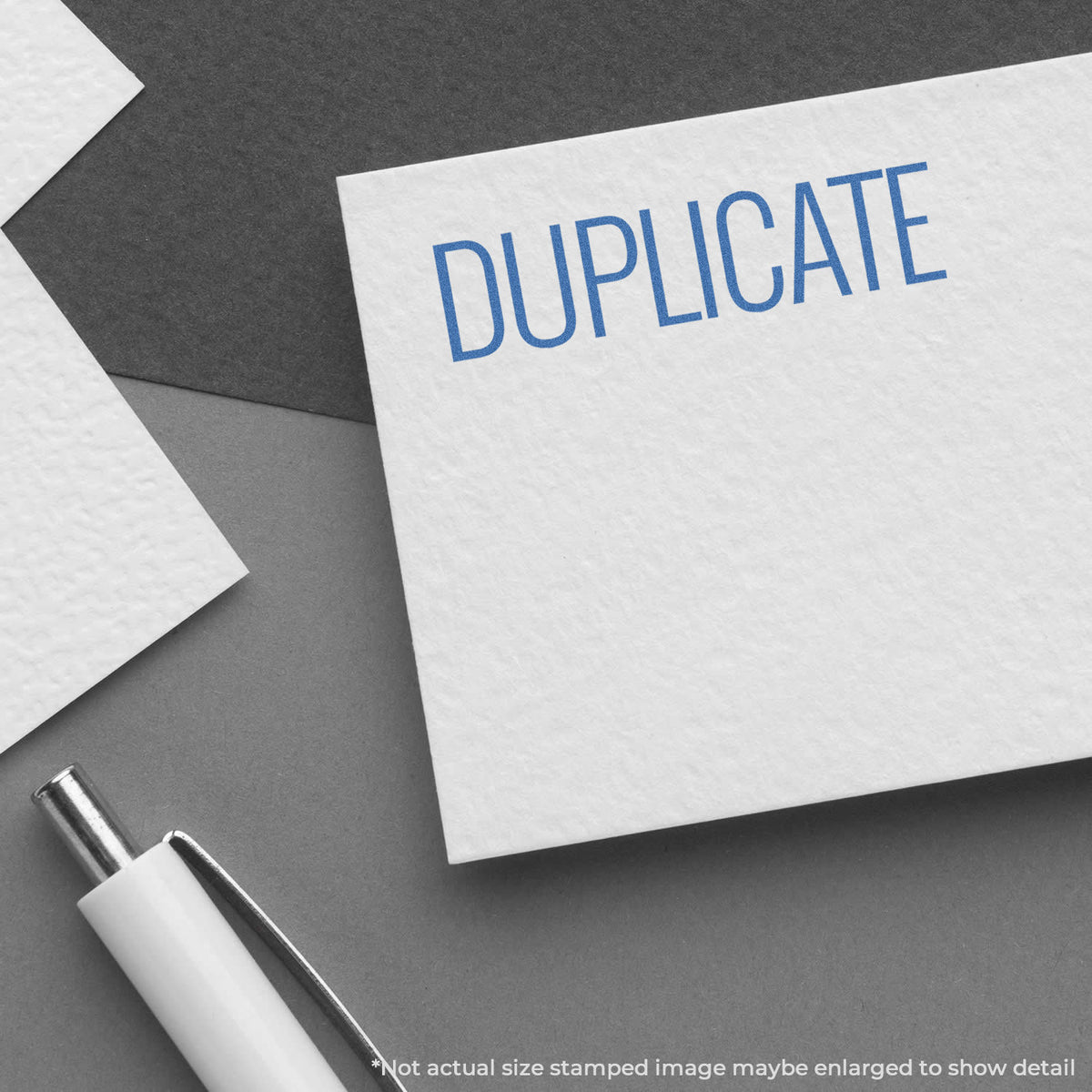 "Duplicate" pre-inked imprint on a page, rectangle shape at 1/2 x 1-5/8 in