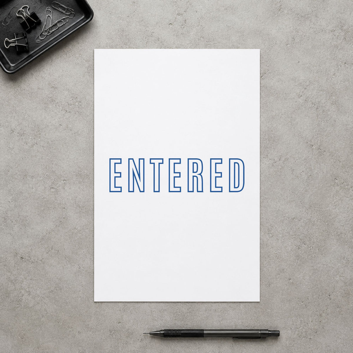 "Entered" Xstamper stamp in use on paper, 1/2 x 1-5/8 in rectangle imprint