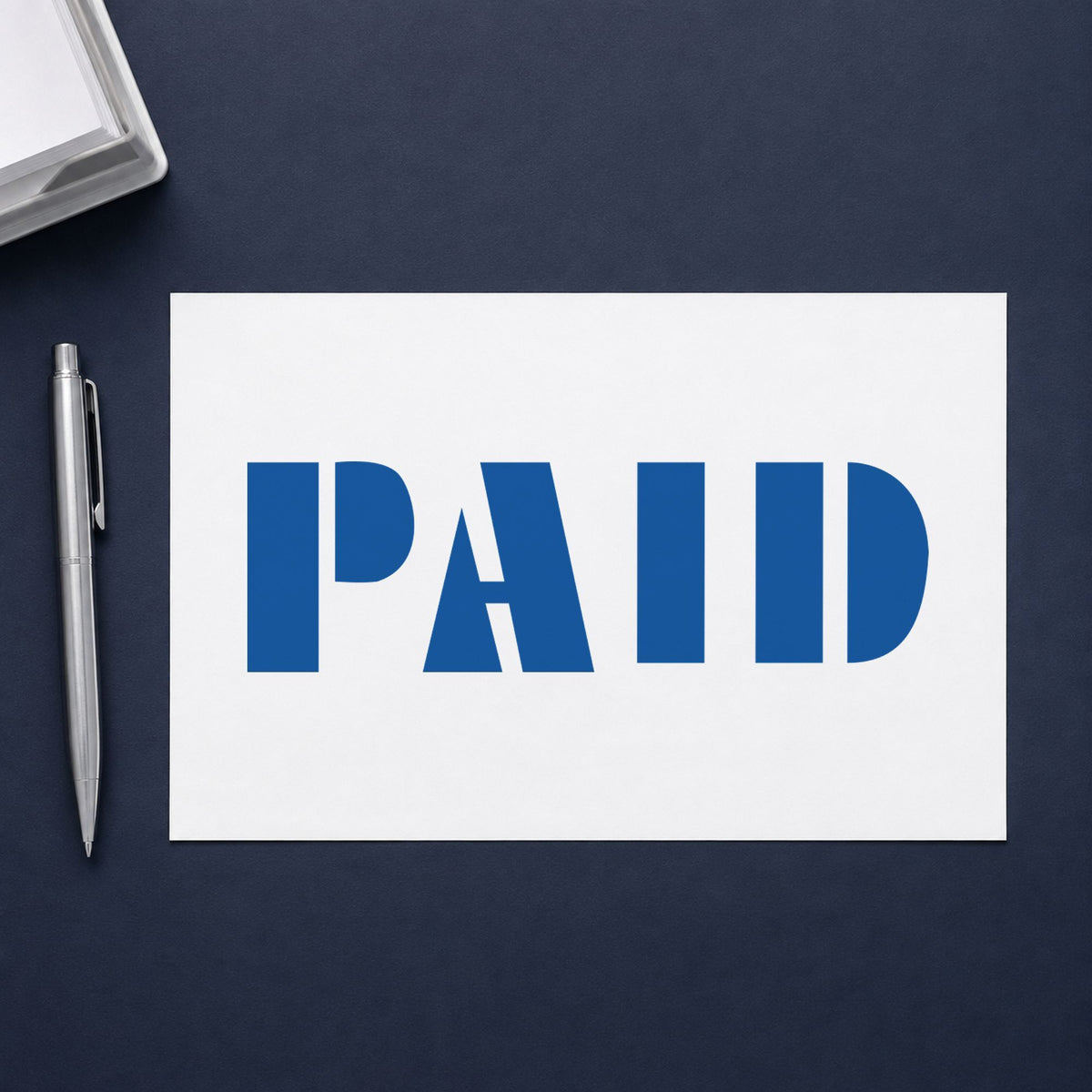 "Paid" Xstamper stamp in use on paper, 1/2 x 1-5/8 in rectangle imprint