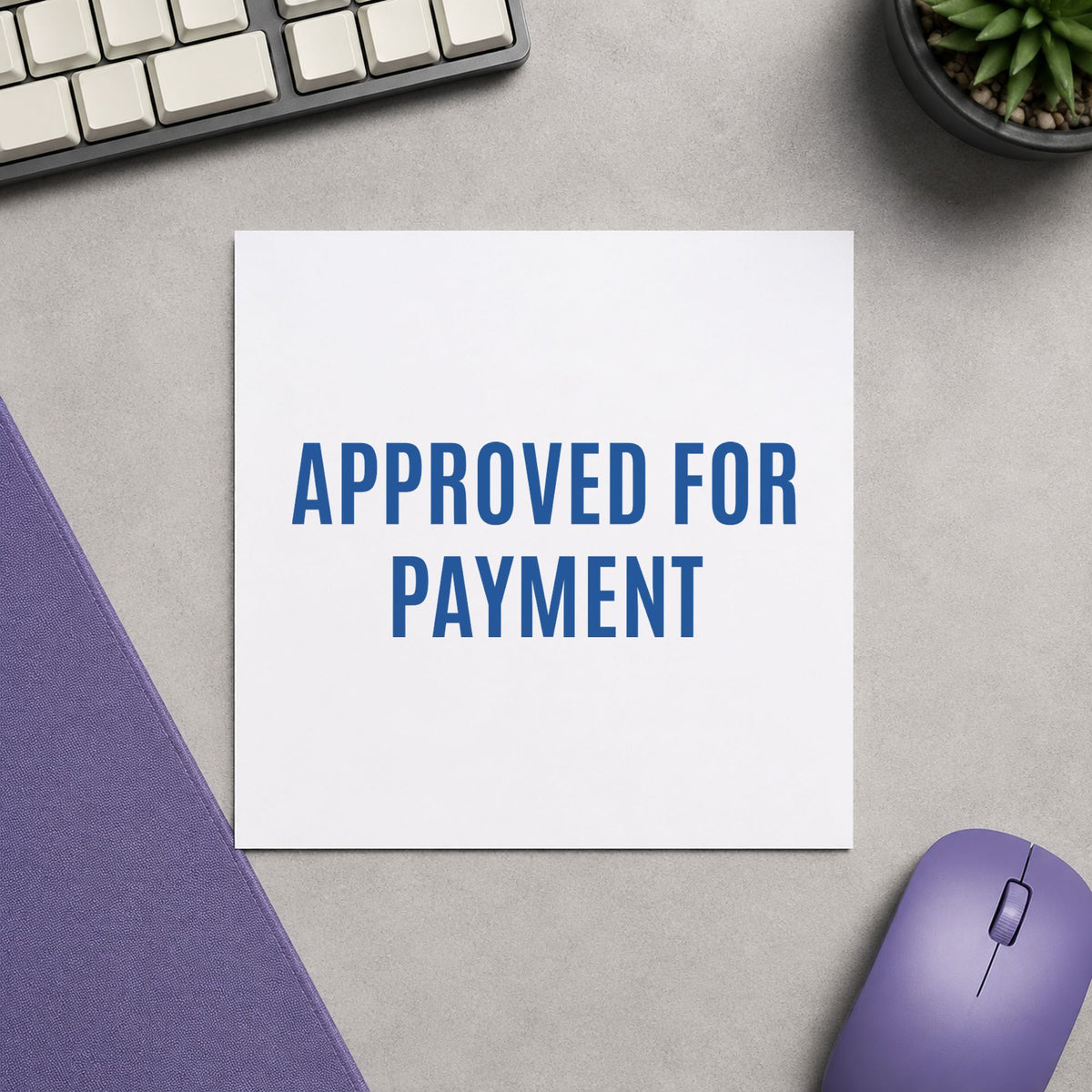 Pre-inked "Approved for payment" stamp marking paperwork in an office setting