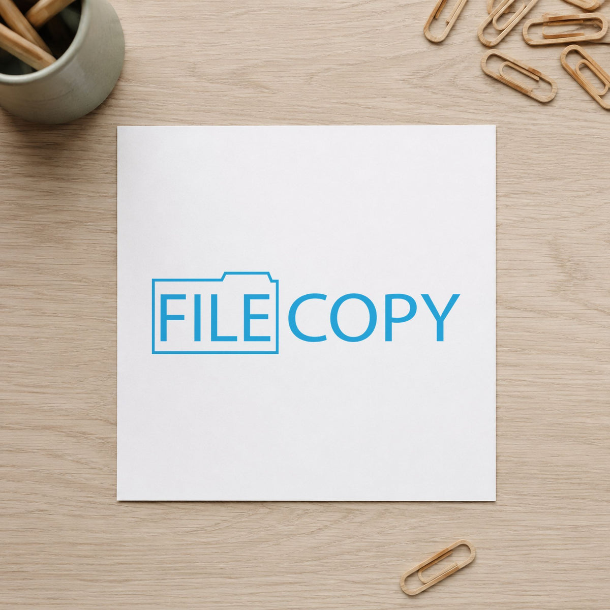 "File copy" Xstamper stamp in use on paper, Approximately 1/2 in tall x 1-5/8 in wide rectangle imprint