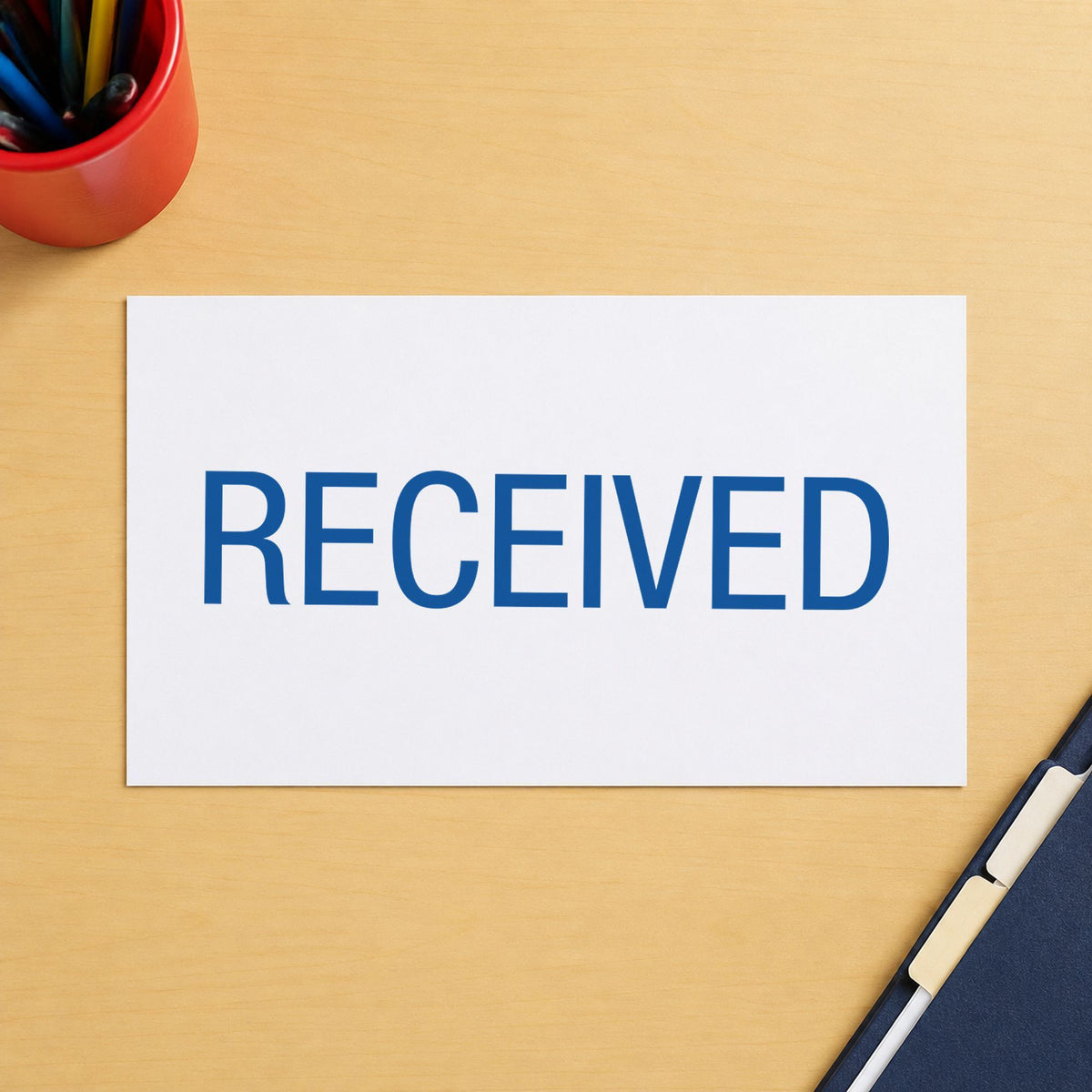 Pre-inked "Received" stamp marking paperwork in an office setting