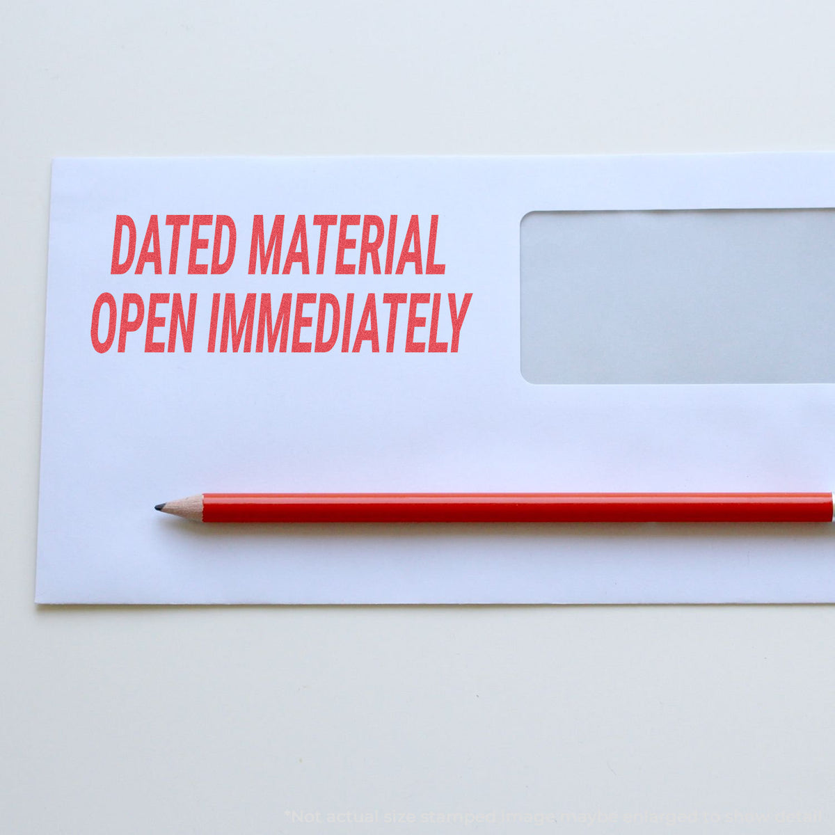 "Dated material open immediately" pre-inked imprint on a page, rectangle shape at 7/8 x 2-3/4 in