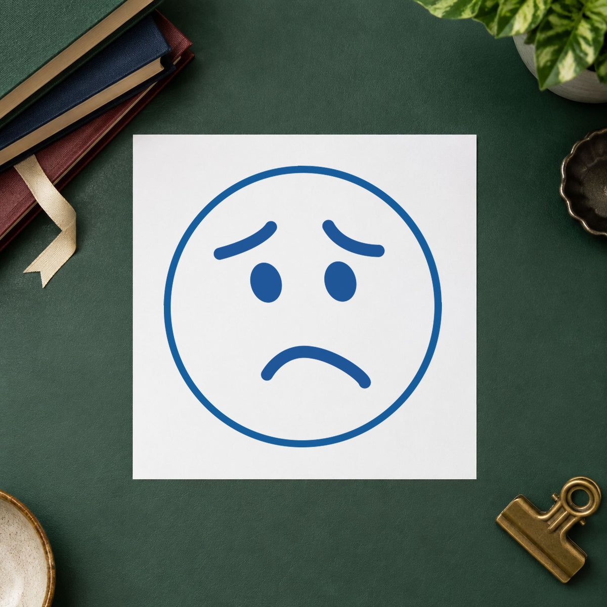"Frown face" Xstamper No. 11305 stamp shown in everyday handling