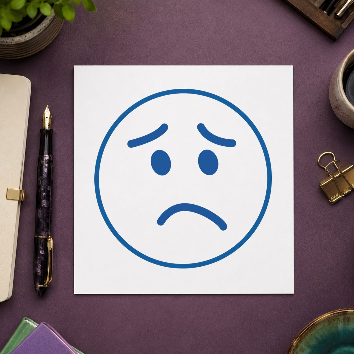 "Frown face" imprint on a printed page, Xstamper No. 11305