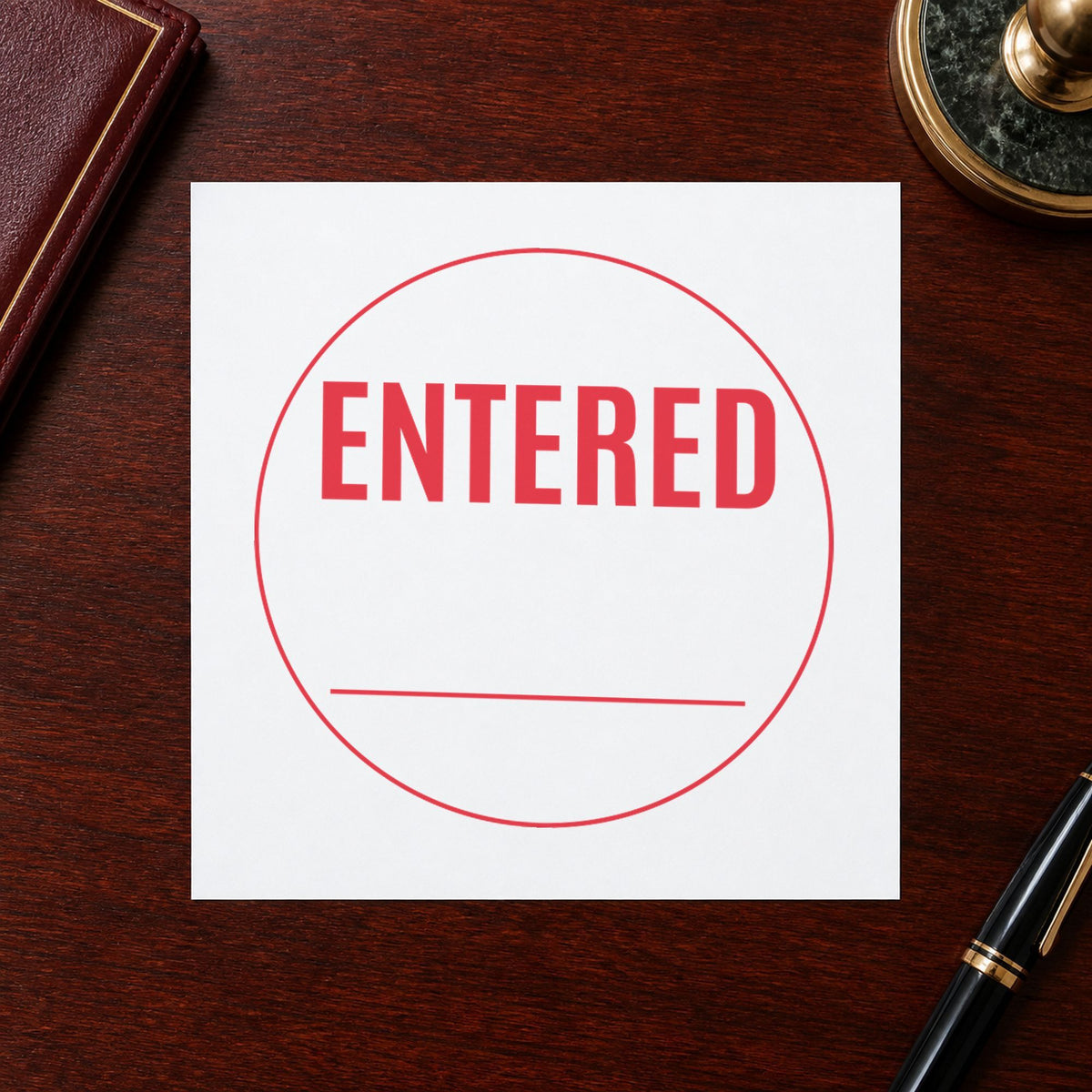 Pre-inked "Entered" stamp applied to a document, Approximately 5/8 in diameter impression