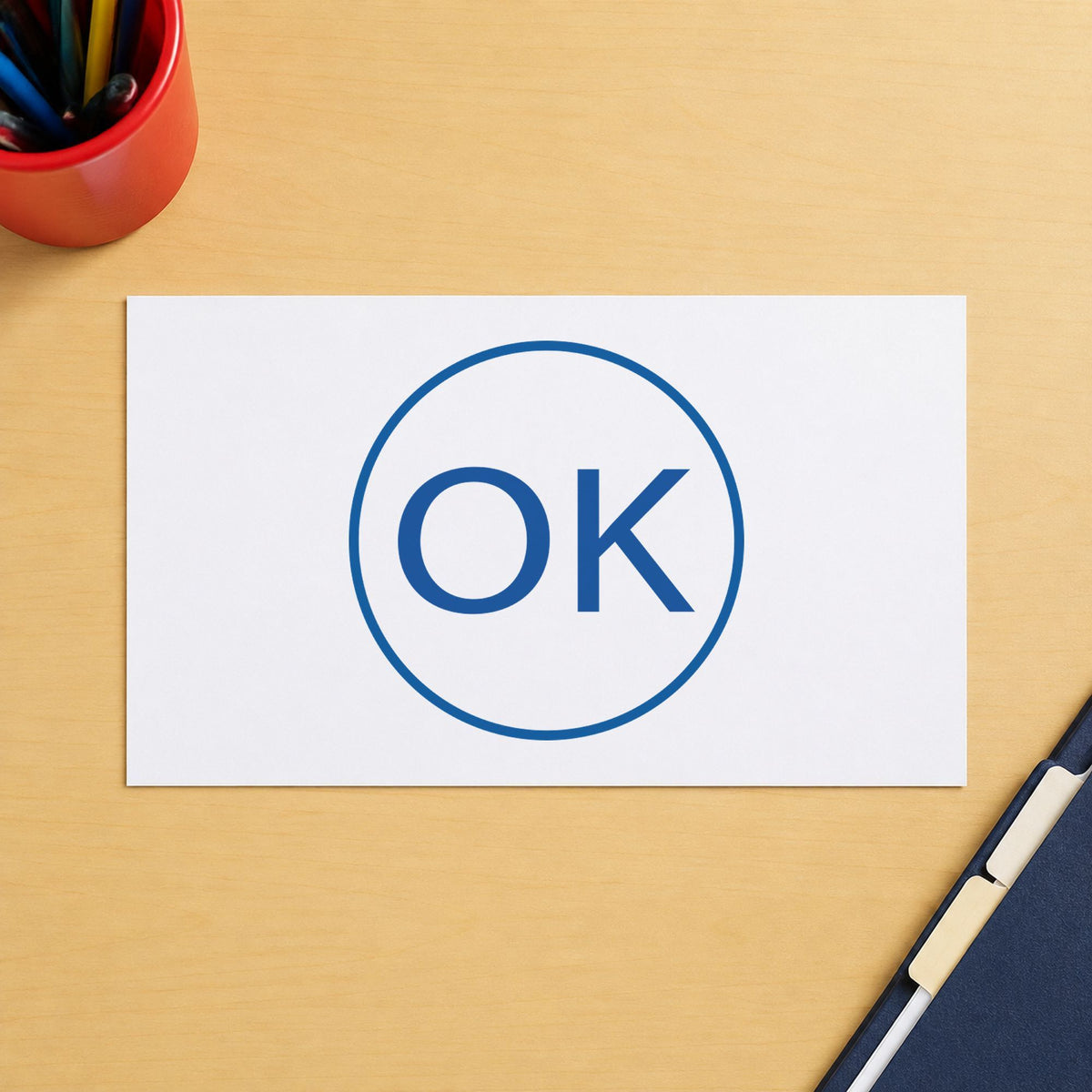 "OK" Xstamper No. 11357 stamp shown in everyday handling