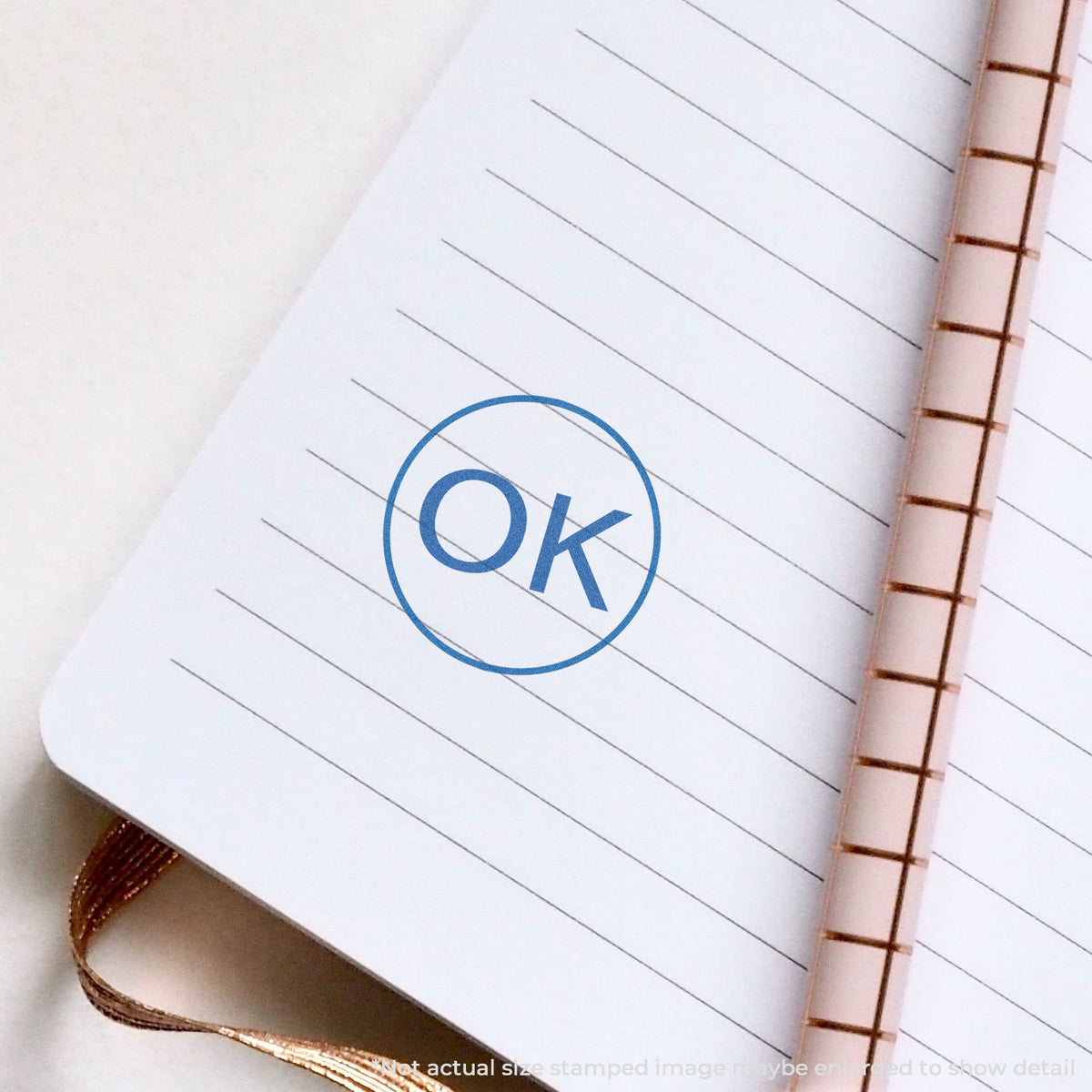 "OK" pre-inked imprint on a page, round shape at 5/8 in diameter