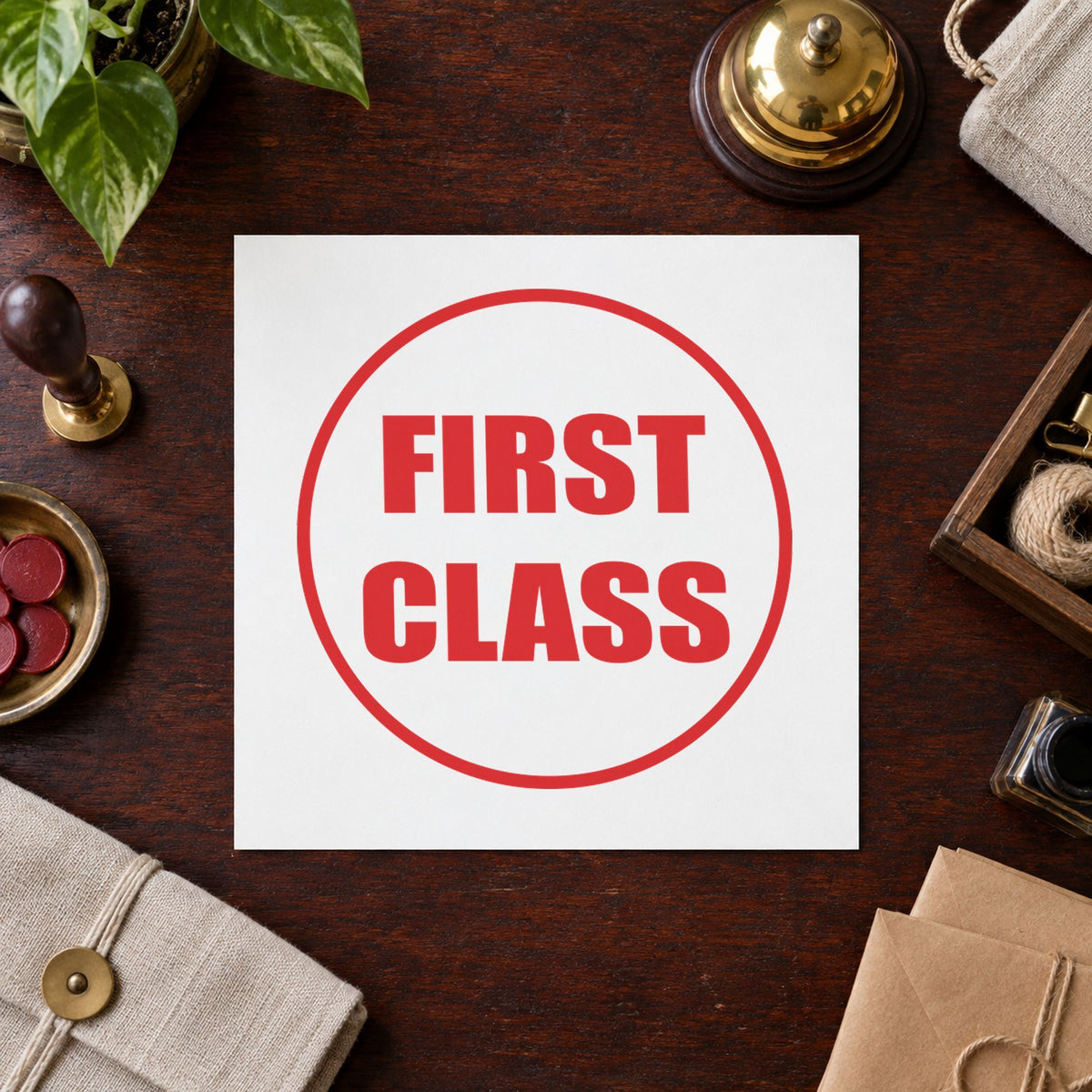 "First class" Xstamper pre-inked stamp beside its round imprint