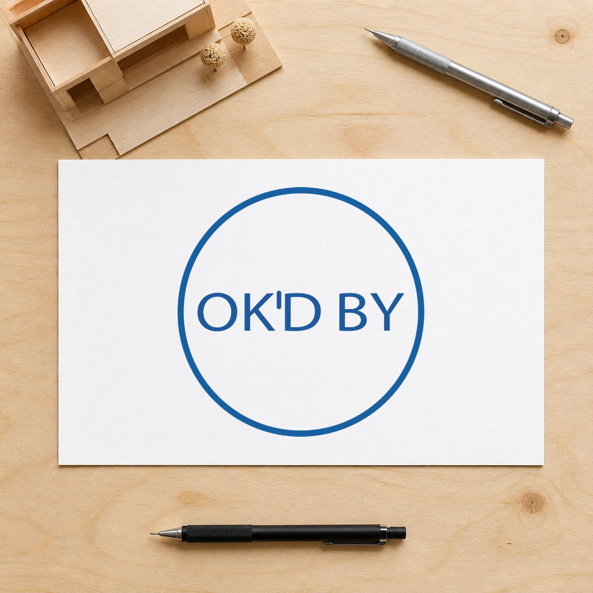"OK'd by" Xstamper stamp in use on paper, 5/8 in diameter round imprint