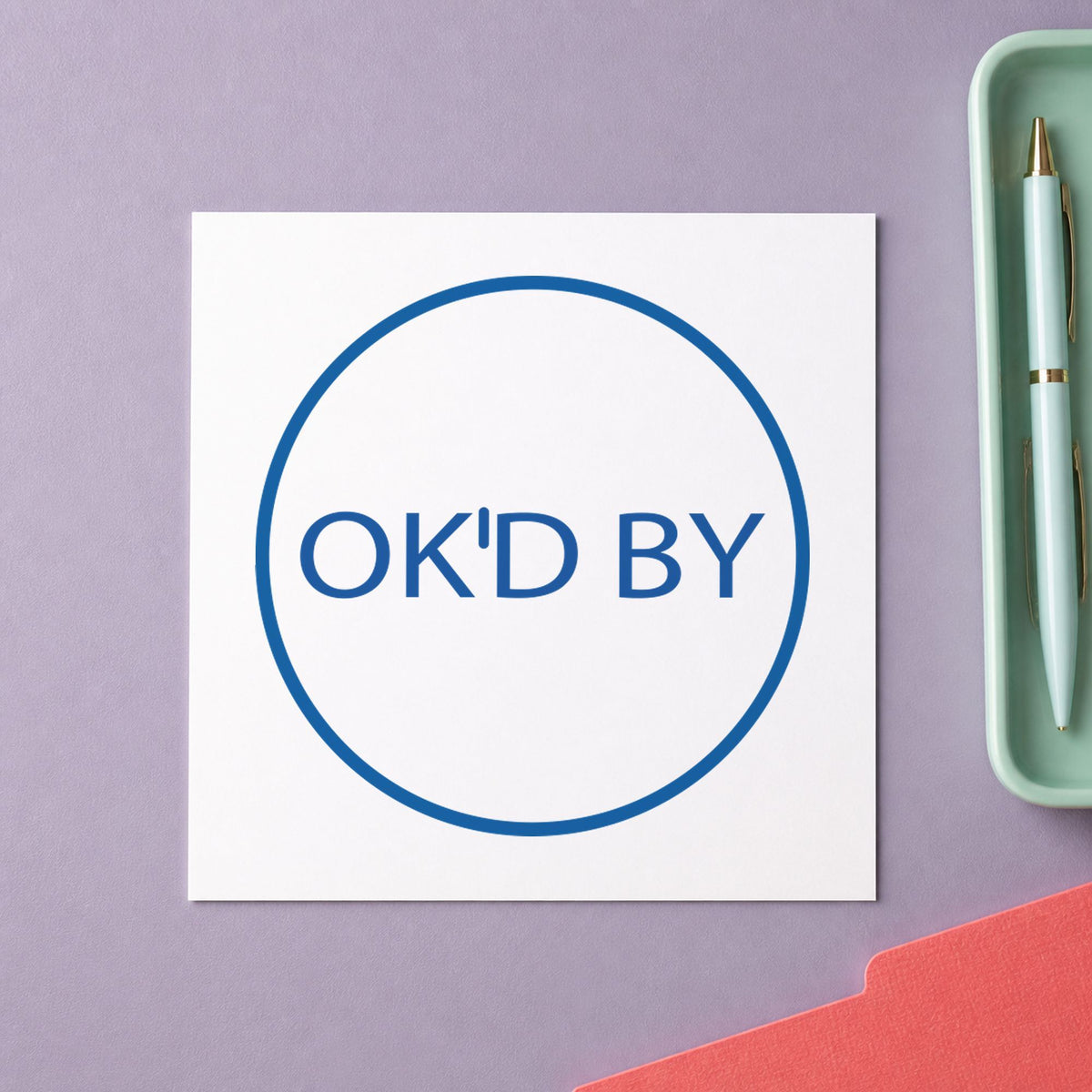 "OK'd by" Xstamper No. 11358 stamp shown in everyday handling