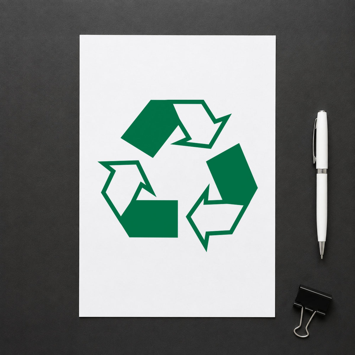 "Recycle logo" Xstamper pre-inked stamp beside its round imprint
