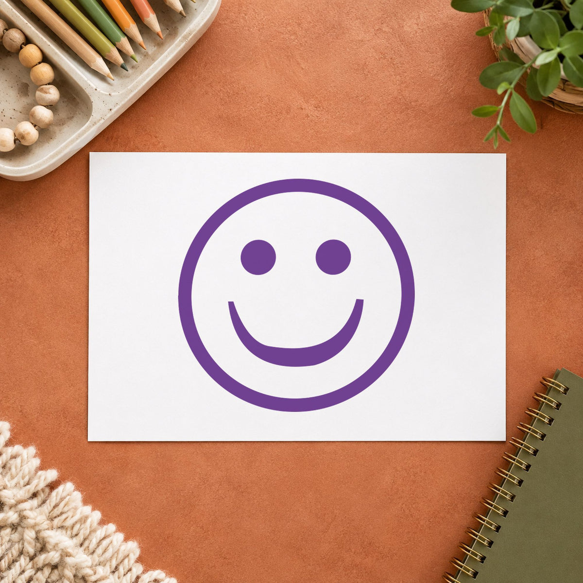 "Smiley face" Xstamper No. 11420 stamp shown in everyday handling