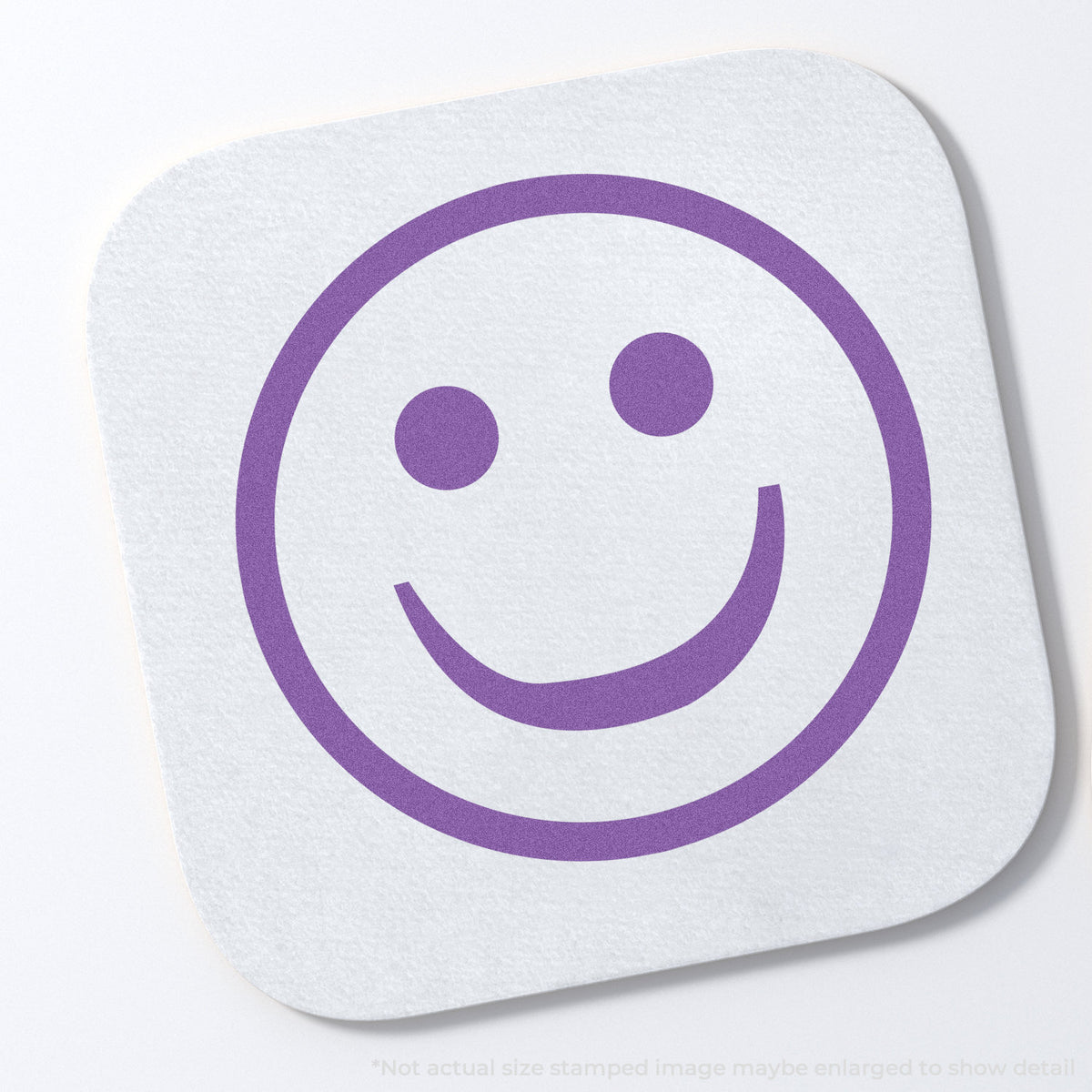 "Smiley face" stamp and its crisp 5/8 in diameter impression on paper