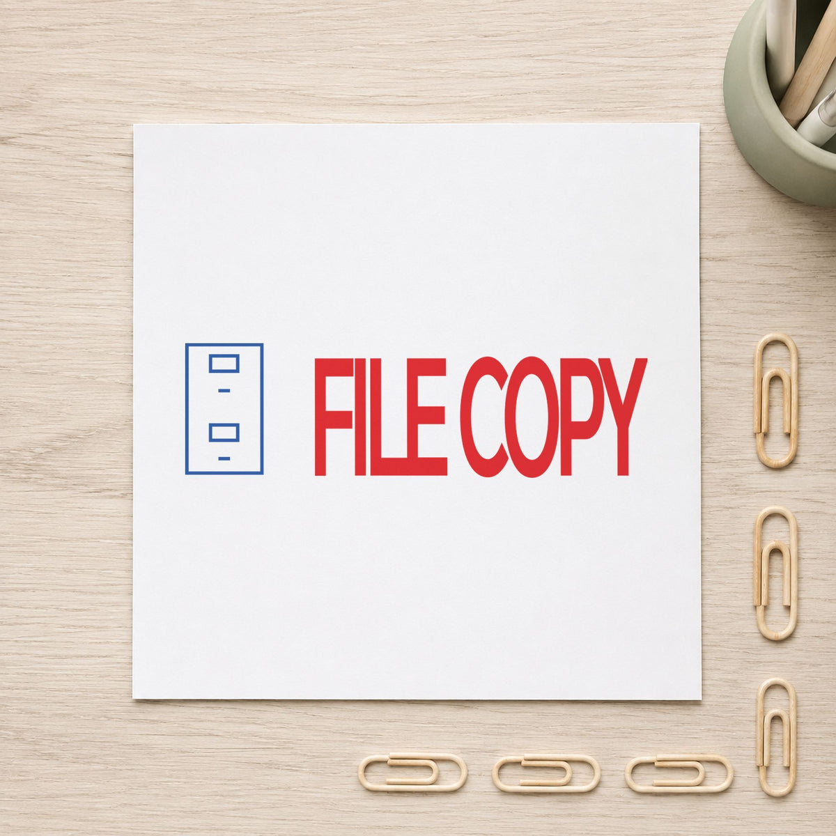 "File copy" Xstamper stamp in use on paper, Approximately 1/2 in tall x 1-5/8 in wide rectangle imprint