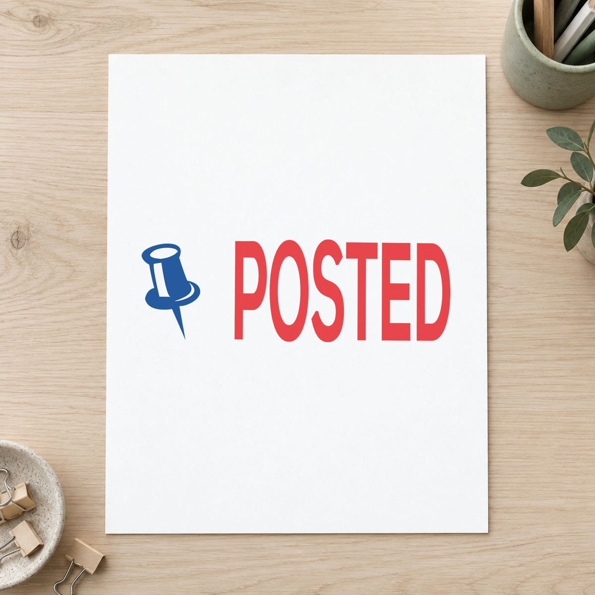 Pre-inked "Posted" stamp marking paperwork in an office setting