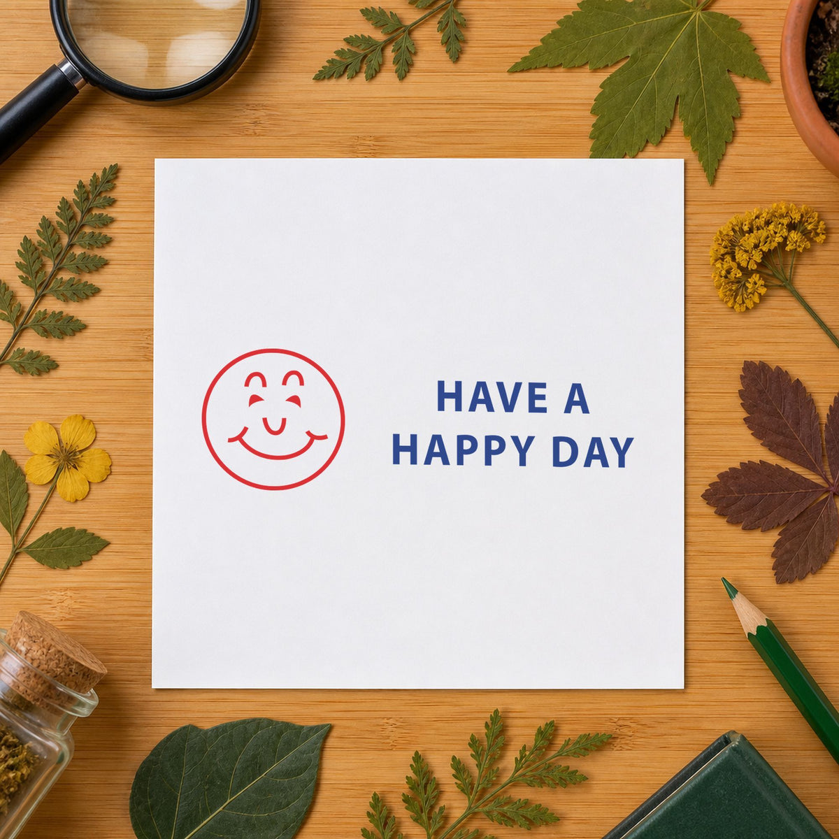 "Have a happy day" Xstamper stamp in use on paper, Approximately 1/2 in tall x 1-5/8 in wide rectangle imprint