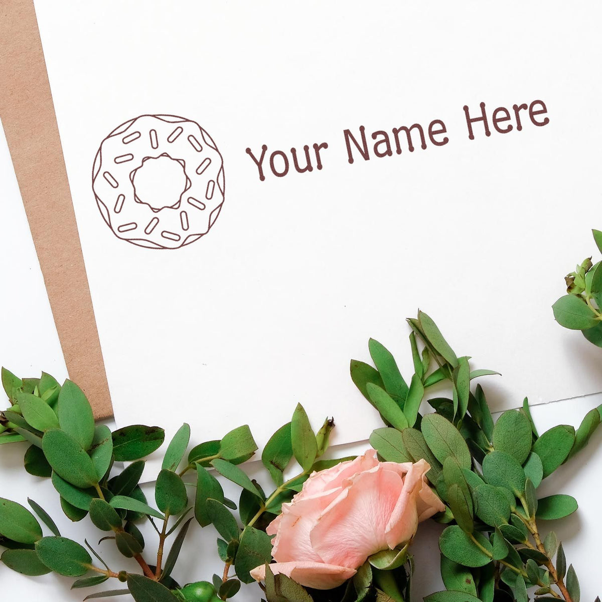 Custom stamp and seal design with donut icon, brown text on white card, framed by green leaves and a pink rose.
