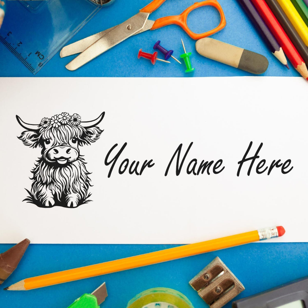 Custom stamp design with black cow illustration and Your Name Here on white paper, surrounded by colorful school supplies.