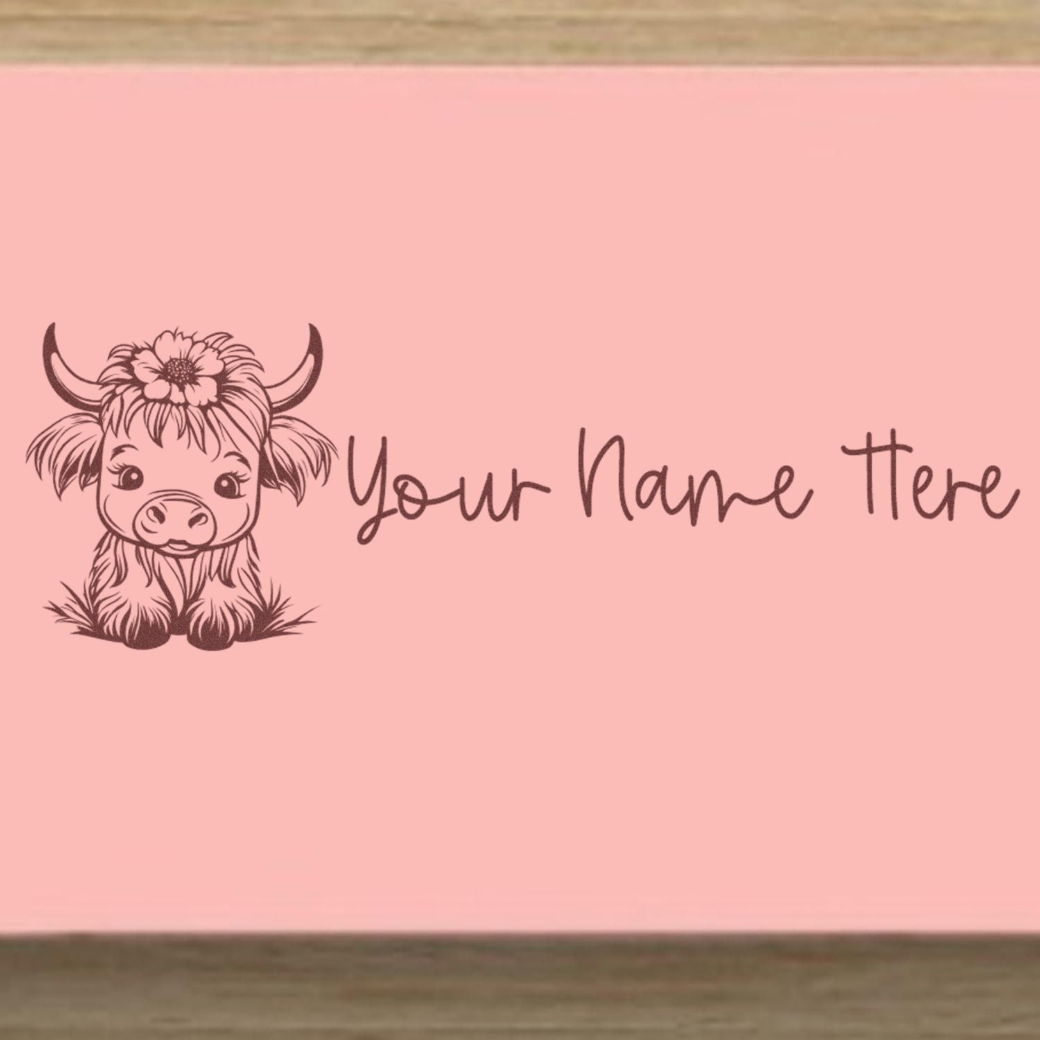 Pink personalized stamp/seal design with brown Highland cow, flower crown, and Your Name Here text