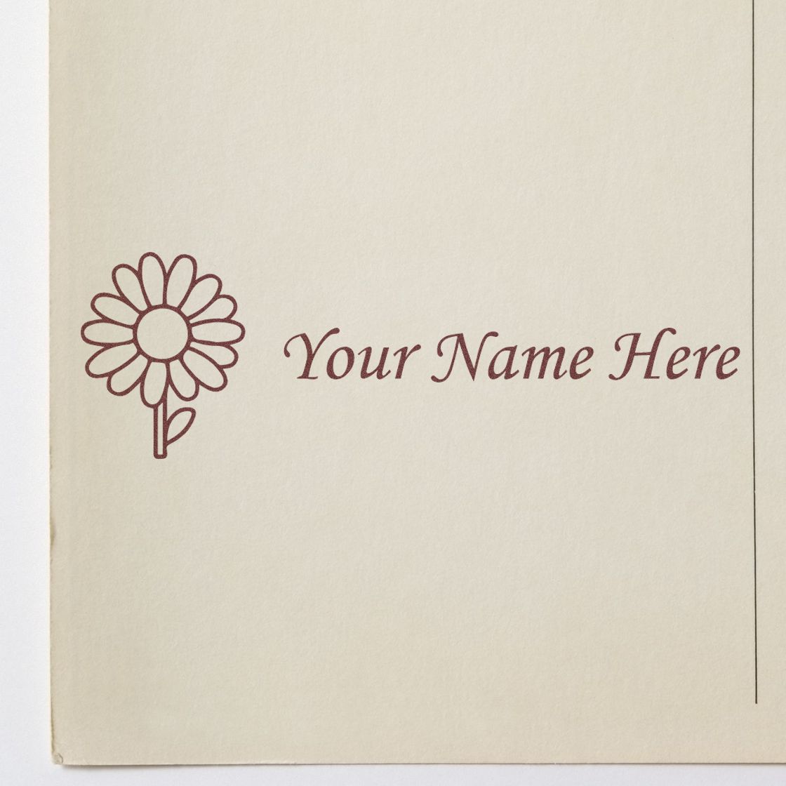 Burgundy custom stamp seal on cream paper, with daisy icon and cursive "Your Name Here" text.