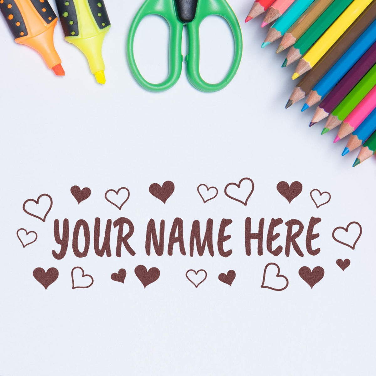 Personalized heart stamp and seal design with colorful pencils, green scissors, and brown lettering on white background