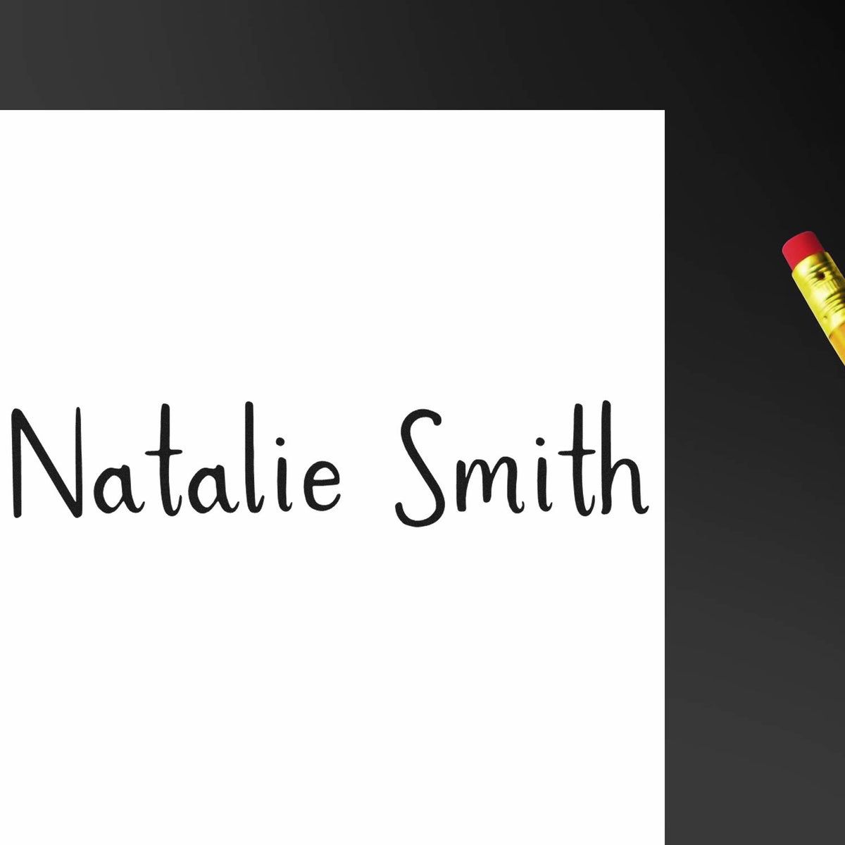 Custom black name stamp reading Natalie Smith on white paper, with a red-and-yellow pencil beside it.