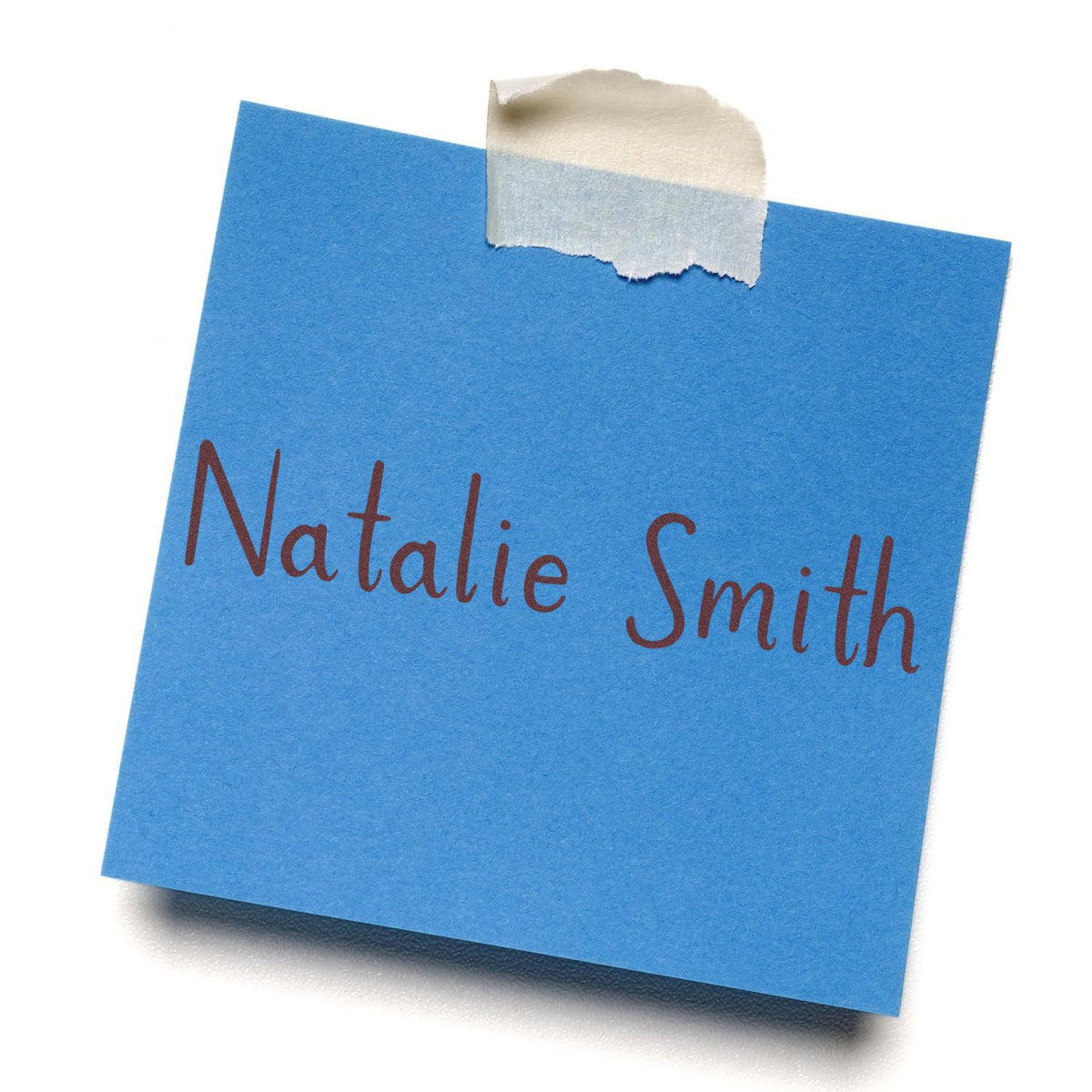 Blue custom name stamp on a note, sealed with masking tape, reading Natalie Smith in brown script.