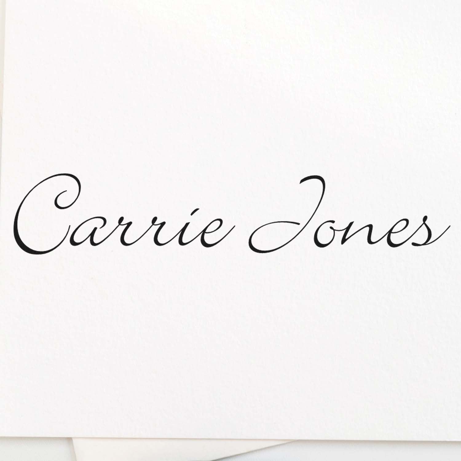 Black cursive Carrie Jones stamp on white paper, elegant seal-style lettering.
