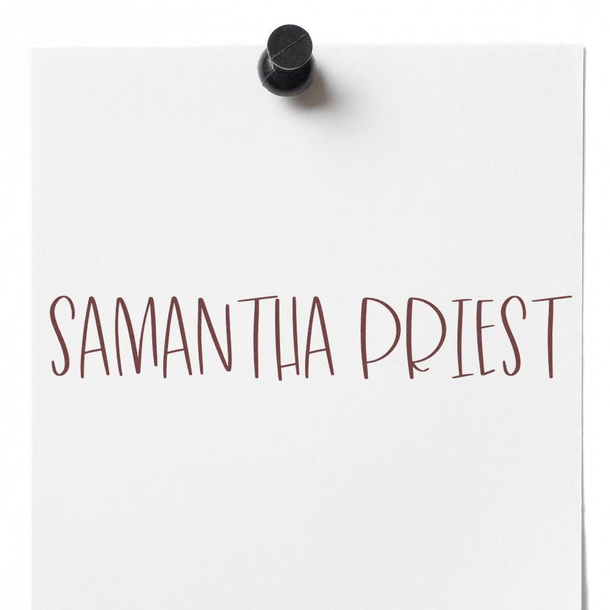 Black seal stamp on white card with maroon Samantha Priest lettering.