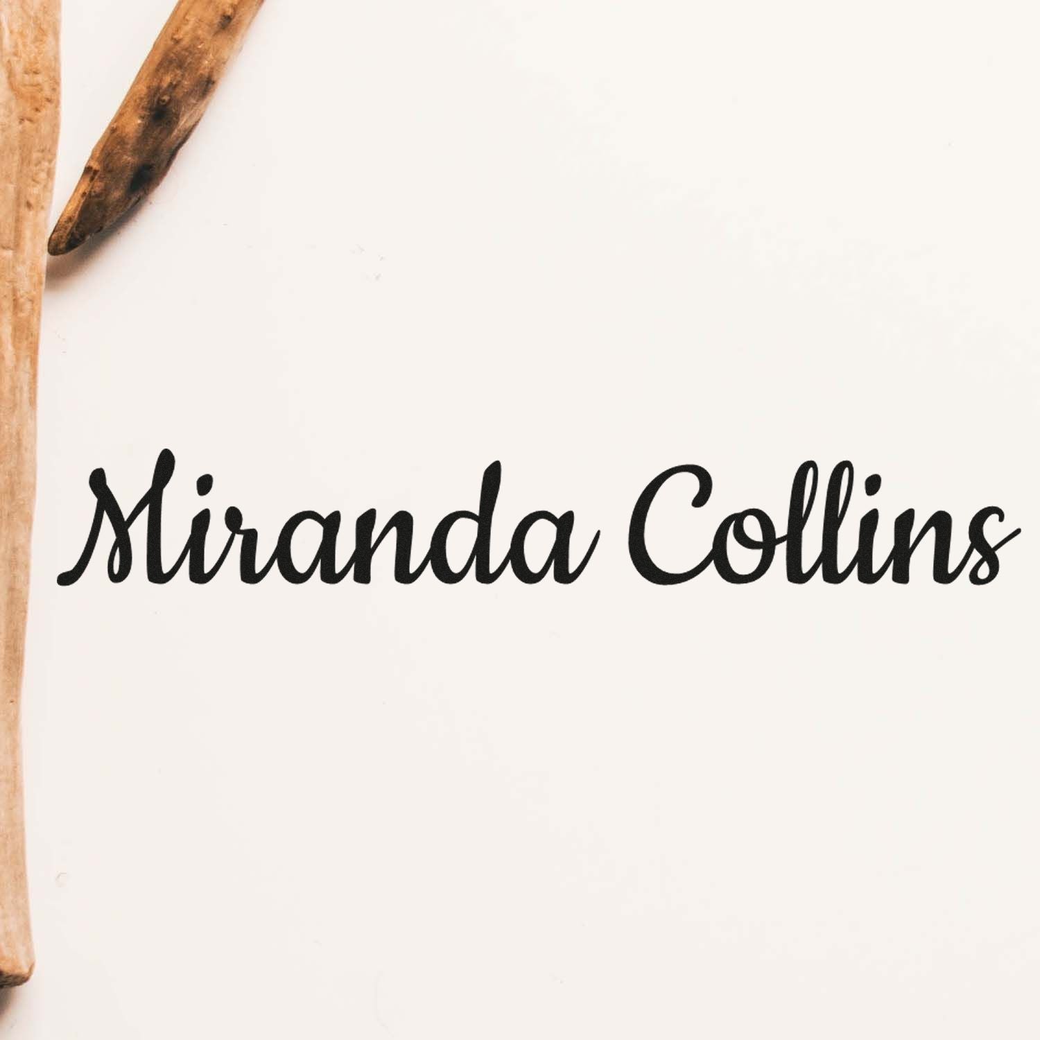 Black script Miranda Collins on white with wooden stamp handles, personalized stamp and seal product