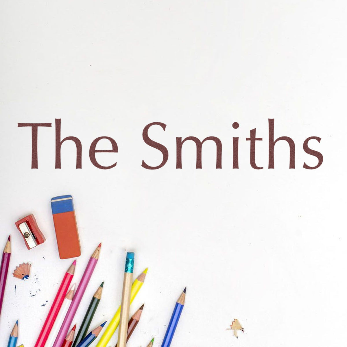 The Smiths maroon logo on white, framed by colorful pencils and a red stamp seal product.